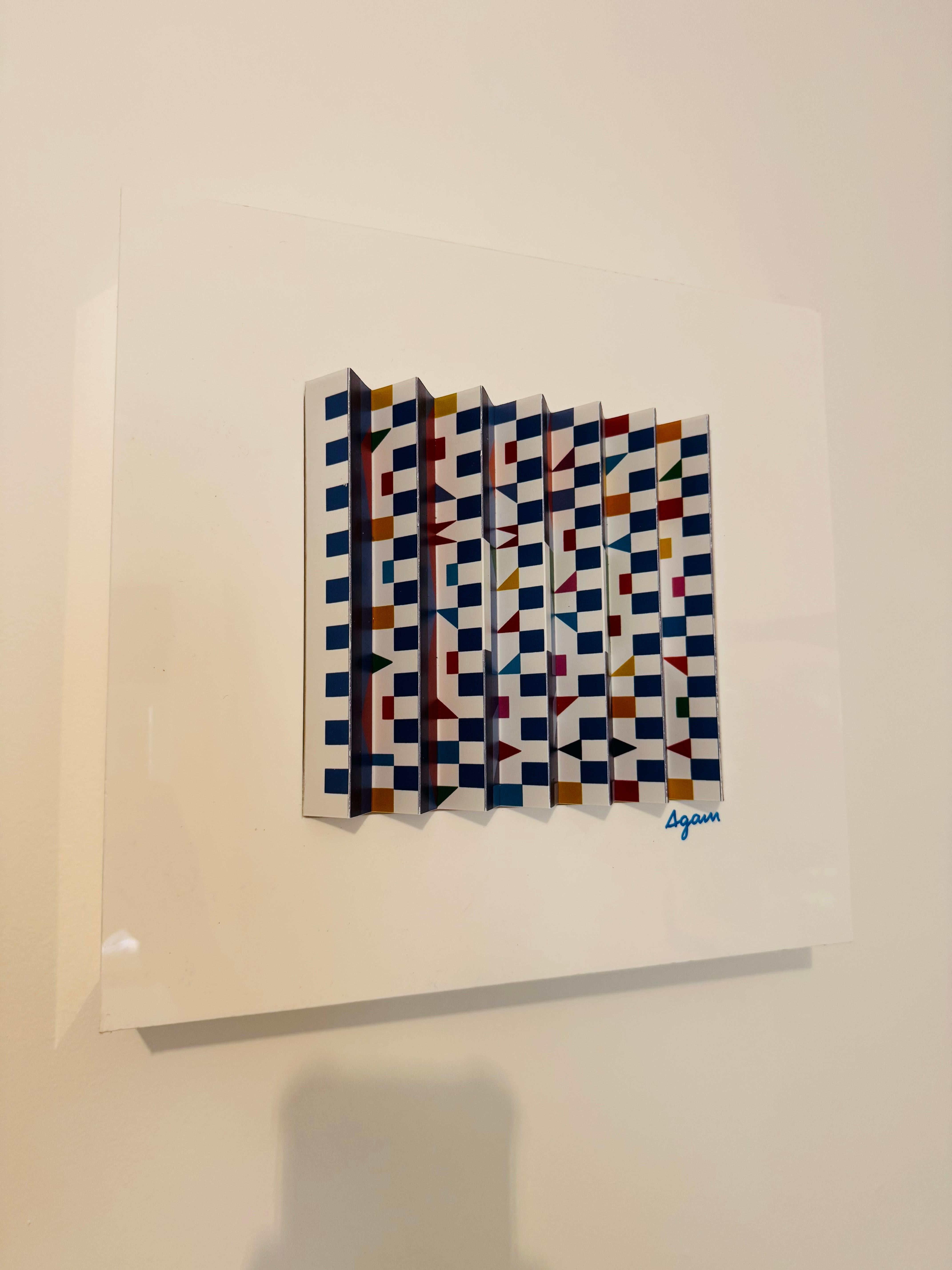 This is an authentic Prismograph by world-renowned Israeli artist Yaacov Agam (b. 1928), one of the leading figures in Op Art and Kinetic Art.

 Details:
	•	Technique: Prismograph (lenticular print)
	•	Medium: Printed on folded panels creating