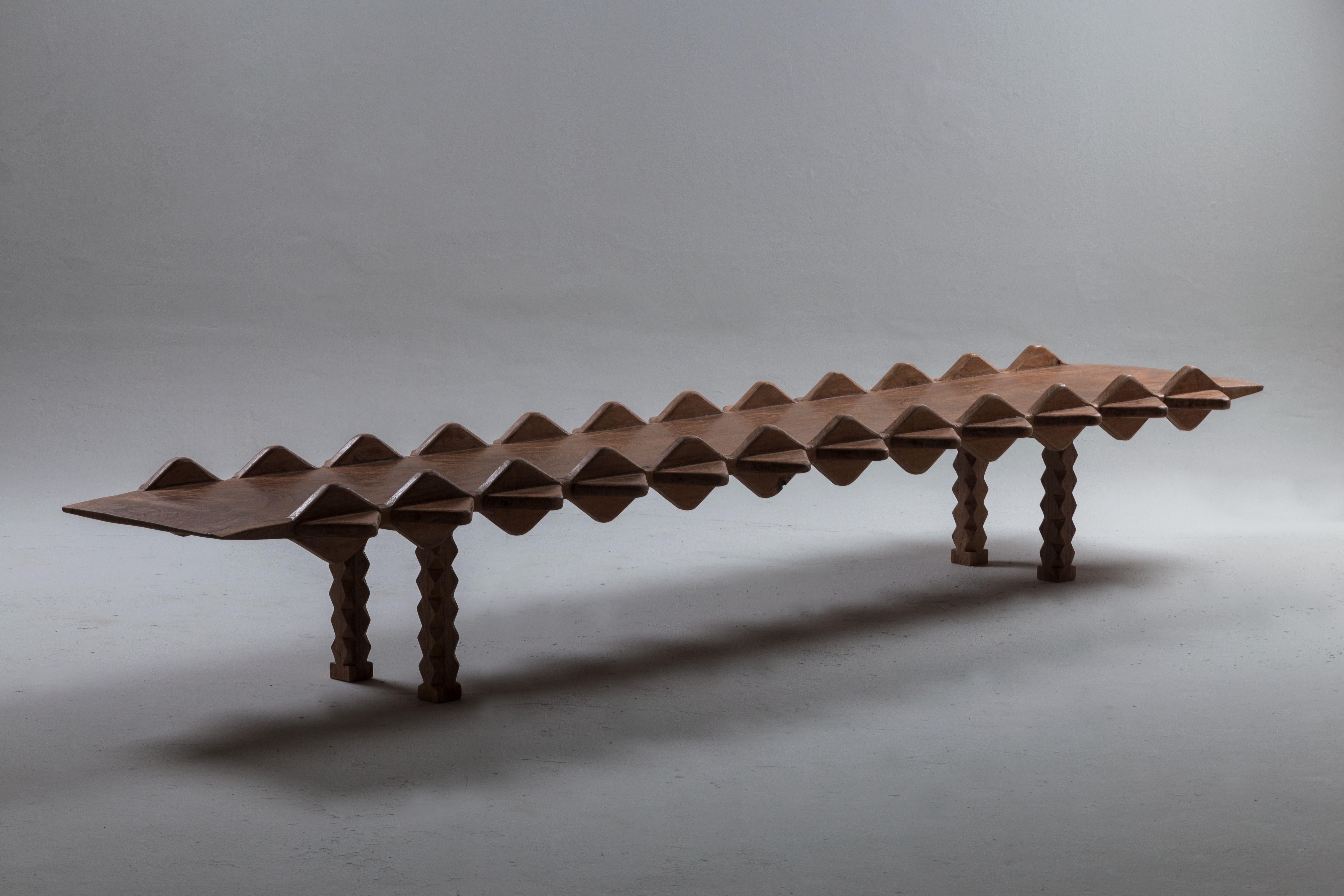 Yacaré low table by Cristián Mohaded
Limited edition.
Dimensions: 54 D x 240 W x 32.2 H cm.
Materials: handmade algarrobo wood + natural wax finishing

This pieces are named after a South American reptile from the caiman alligator family. It