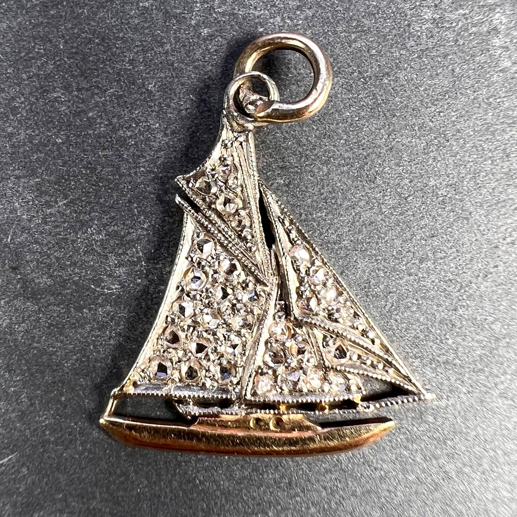 An antique platinum topped 14 karat (14K) yellow gold charm pendant designed as a sailboat or yacht, set with 31 rose-cut diamonds estimated to weigh a total of 0.65 carats. Unmarked but tested for 14 karat gold and platinum.

Dimensions: 2 x 1.7 x