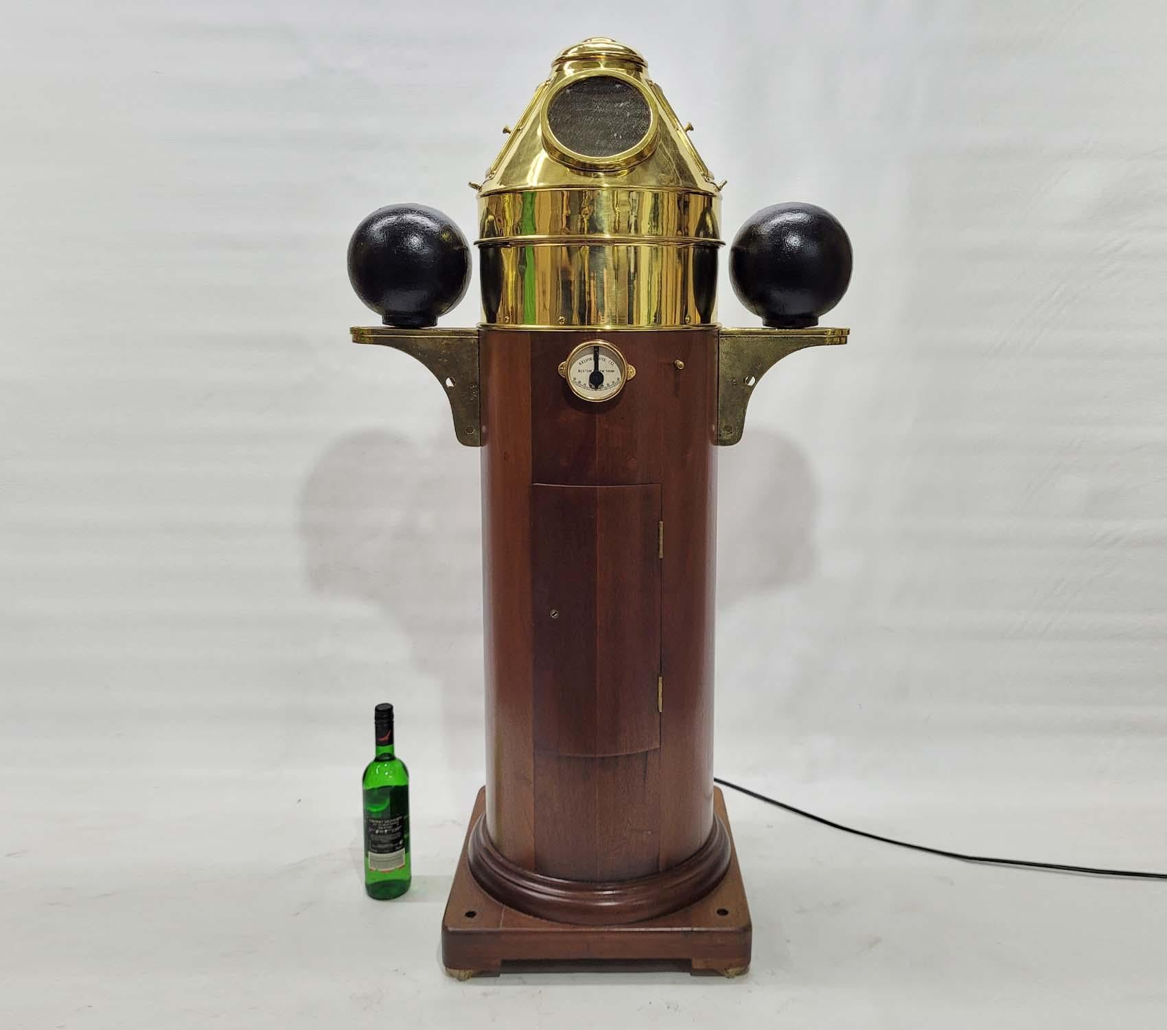 First class yacht binnacle by Kevin Hughes of New York and Boston. Varnished wood base with hinged door. A bronze clinometer is mounted to the base. Iron compensating balls are mounted to brass brackets. The brass wood and band hold a gimballed