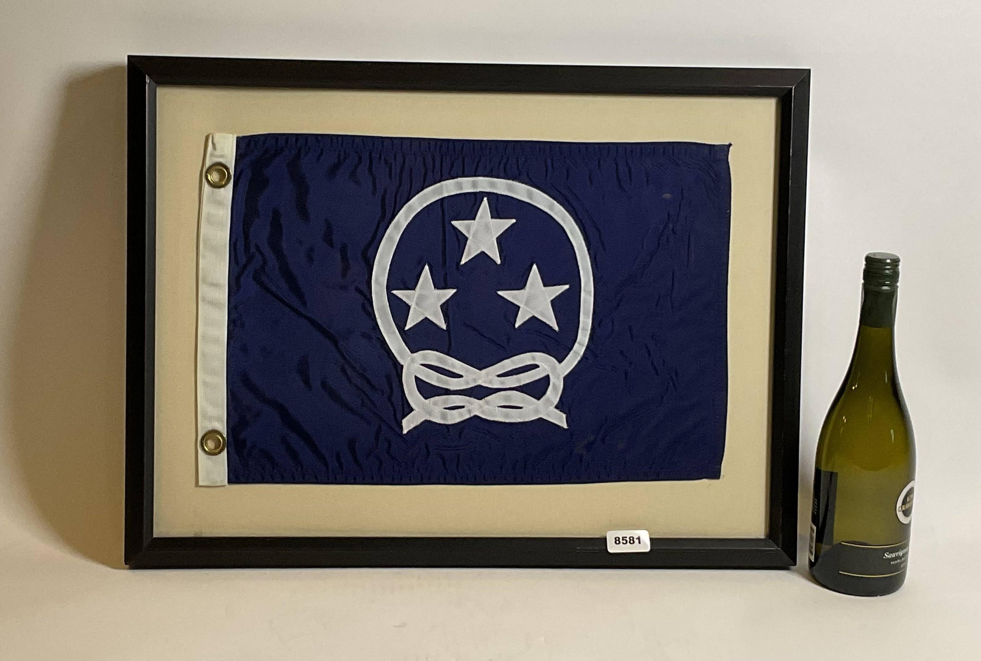 Nautical Boat Flag in Frame. Yacht club commodores flag showing three stars surrounded by a knotted rope. White hoist with brass grommets. Set into a custom frame.

Weight: 5 lbs
Overall Dimensions: 18