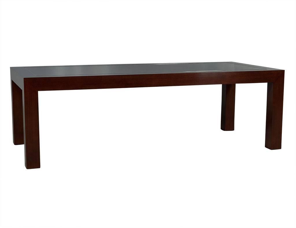 This Art Deco modern dining table is designed by Ralph Lauren. Composed of solid mahogany in a flamed finish with inset polished nickel inlay detail, this piece is Classic with the perfect amount of flair for any dining room.

Price includes