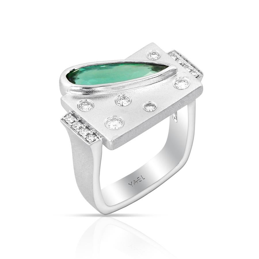 This ultra modern ring plays with shapes, starting with a white gold rectangle and piercing it with a wedge of green tourmaline. Bubble-shaped round diamonds float throughout the rectangle, echoing the curve of the tourmaline. The shank echos the