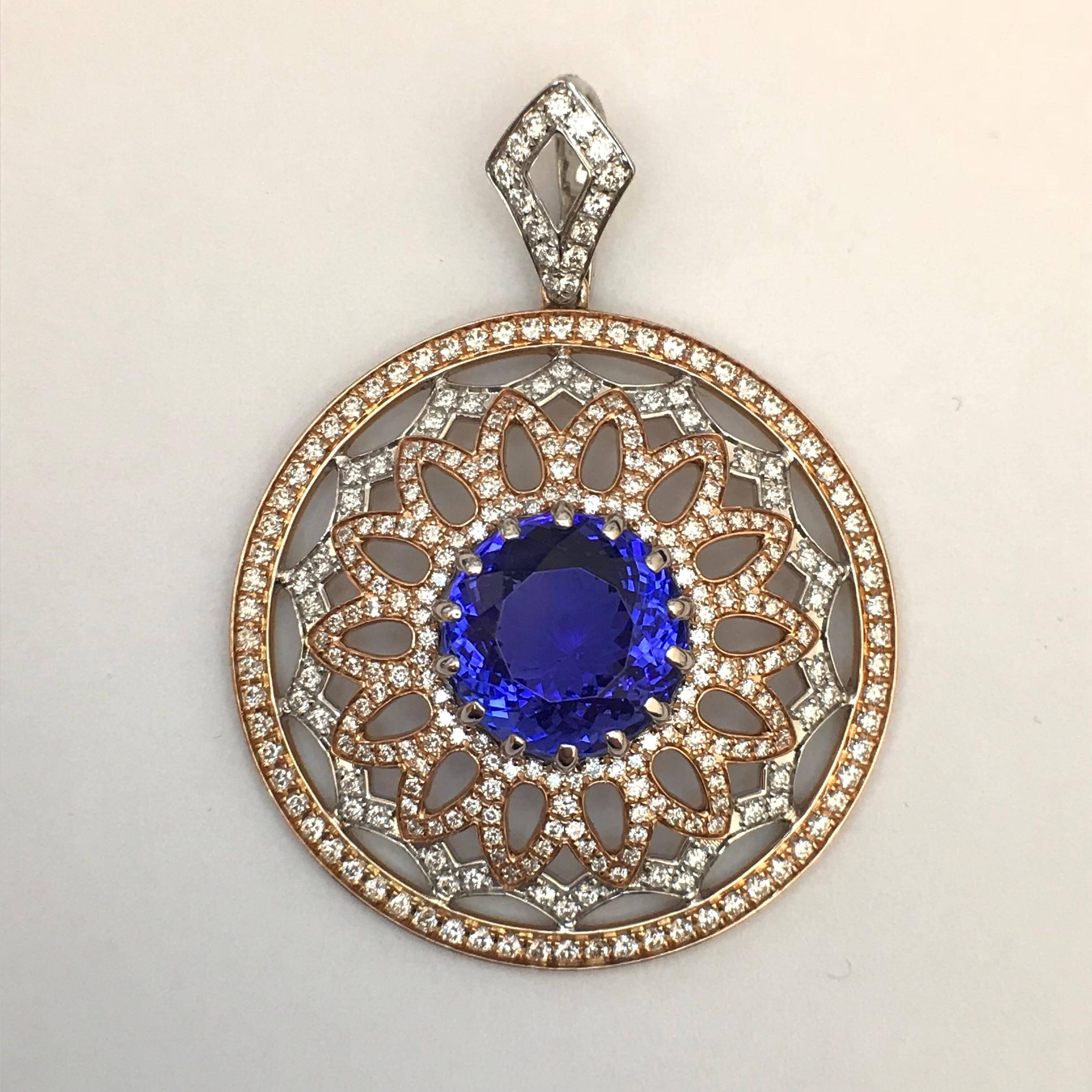 As inspired as the rose window of a cathedral, this pendant centers a tanzanite of an intense blue-purple. It is surrounded by open petals of rose gold that overlay a scalloped edge of white gold, all framed within a circle of rose gold. The white