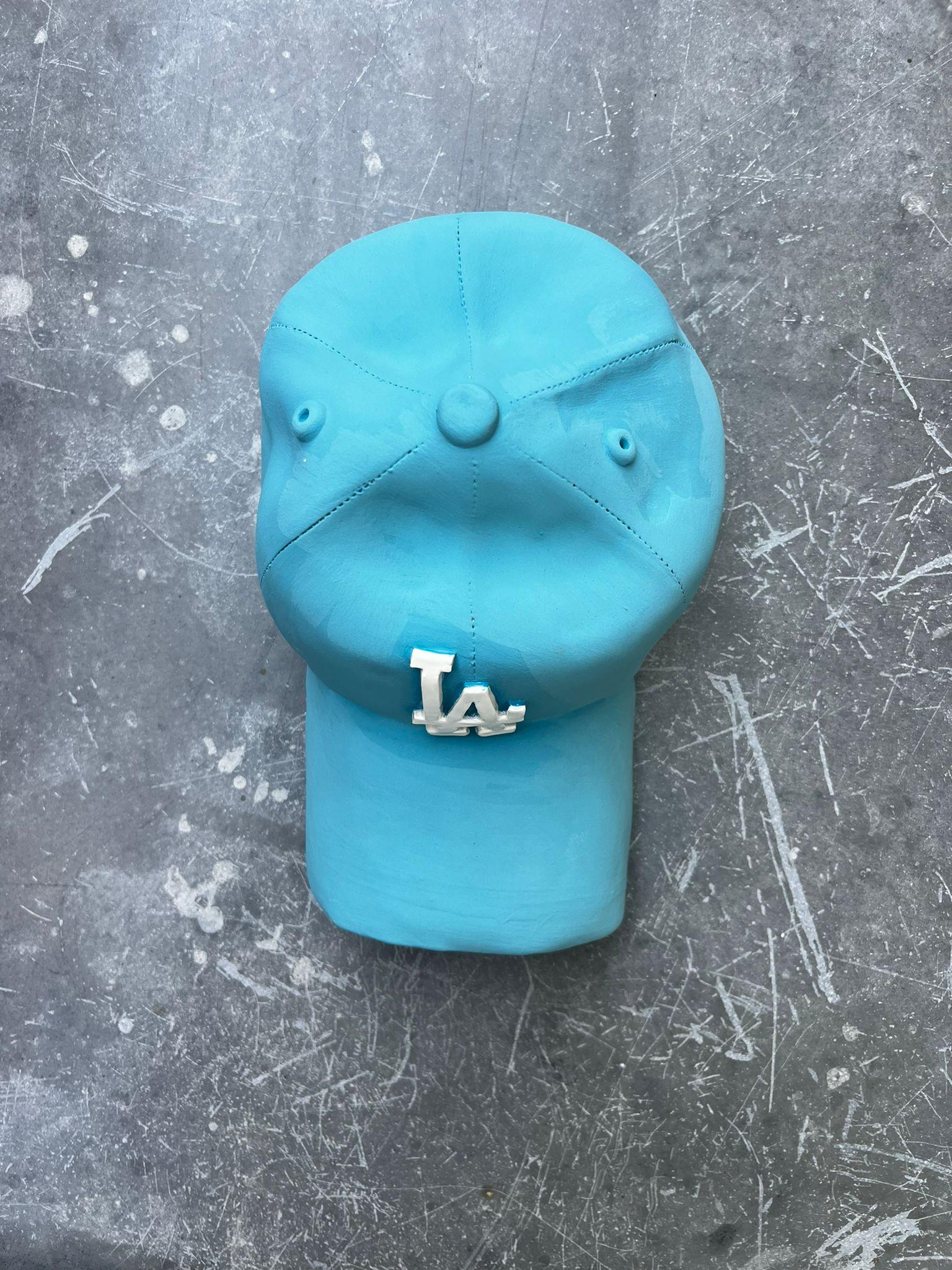 Ceramic LA Dodgers cap sculpture (light blue) - figurative sculpture - Blue Still-Life Sculpture by Yael Yanay