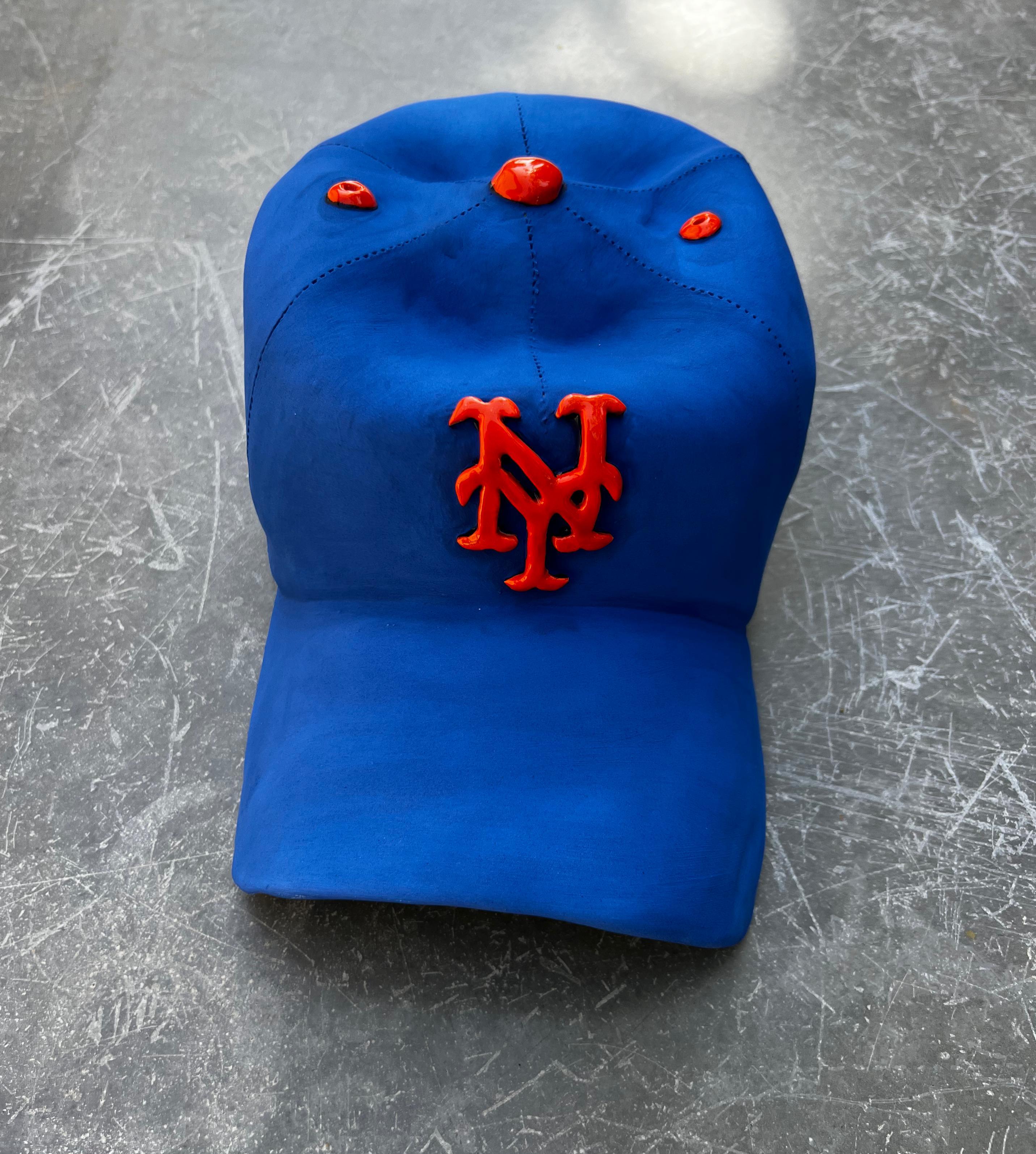 This beautiful one of a kind ceramic hand made NY Mets cap is from Yael Yanay’s latest body of works.

These hand-crafted ceramic hats  are meticulously designed to resemble iconic baseball caps, complete with a realistic NY Mets logo. Made entirely
