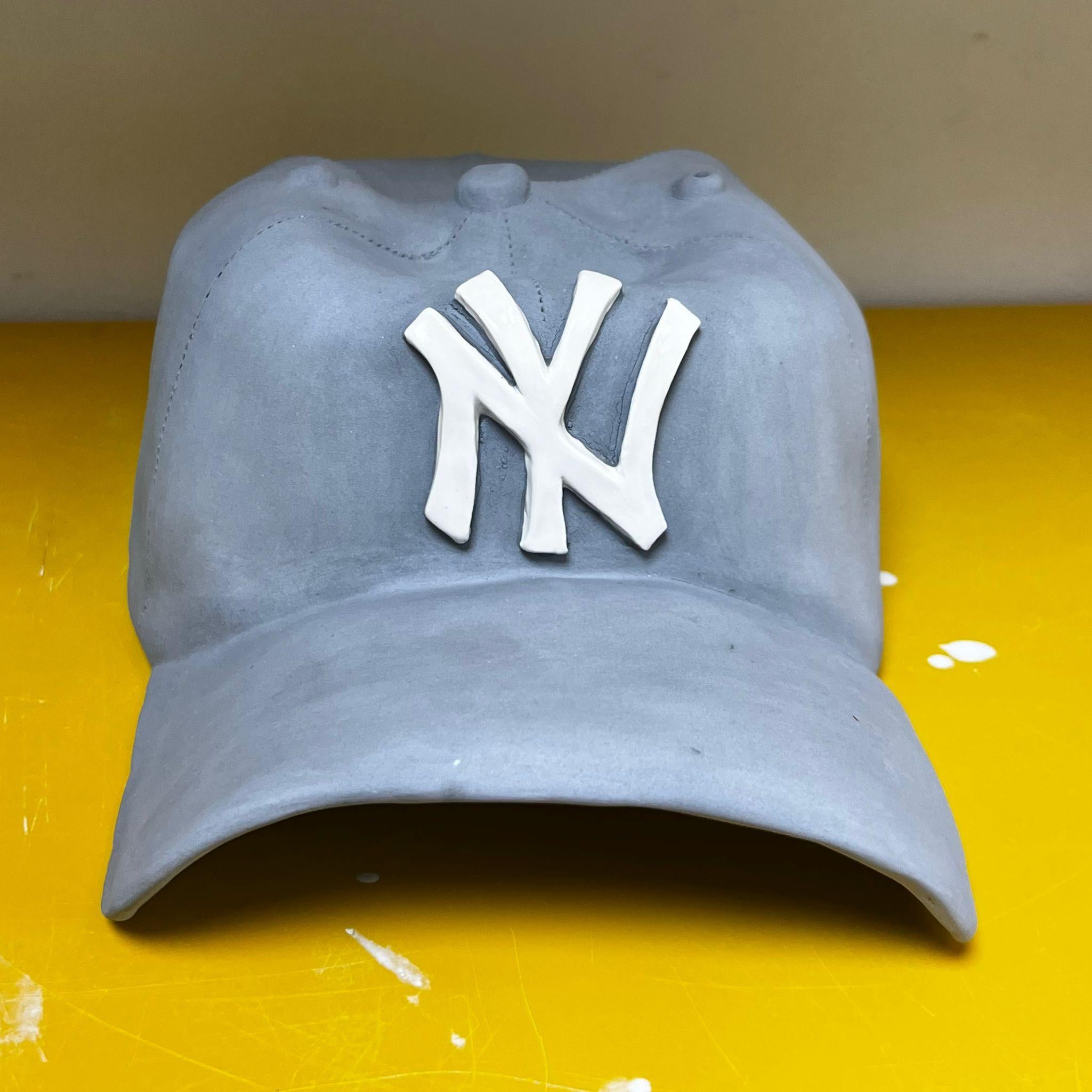 Ceramic NY Yankees cap sculpture (grey) - figurative sculpture - Sculpture by Yael Yanay