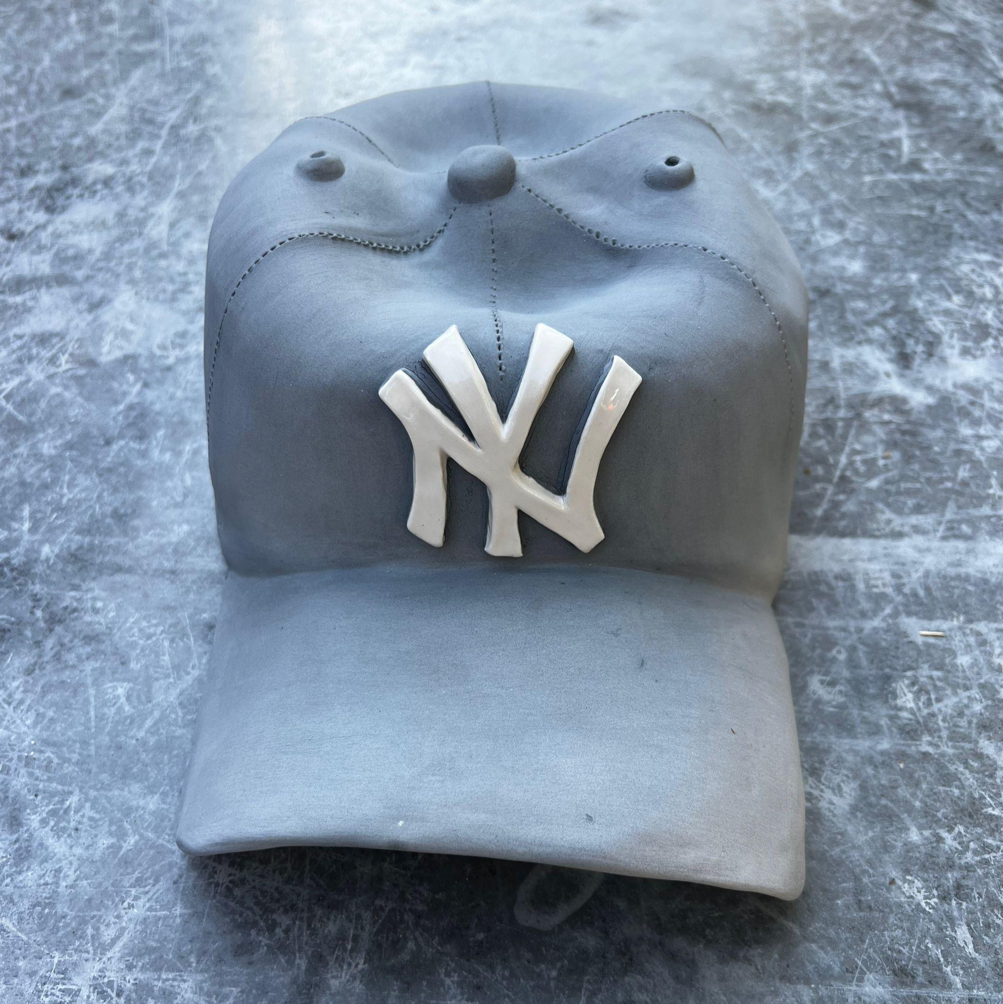 Ceramic NY Yankees cap sculpture (grey) - figurative sculpture - Gray Still-Life Sculpture by Yael Yanay