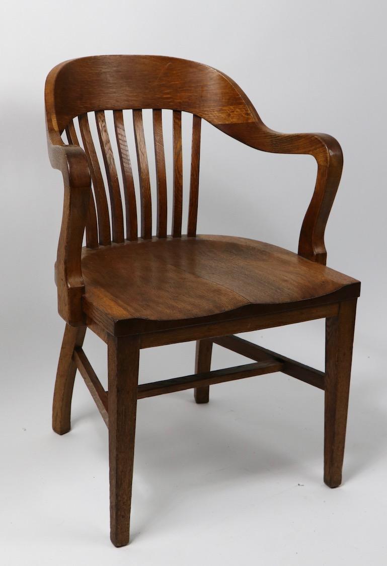 Vintage office chair, this form is commonly referred to as a Bank of England, or Yale Library, chair. This example is oak, it is in clean, ready to use condition. Seat H 17.5 x Arm H 28 x Total H 33 inch. Design Classic from the Golden Era of