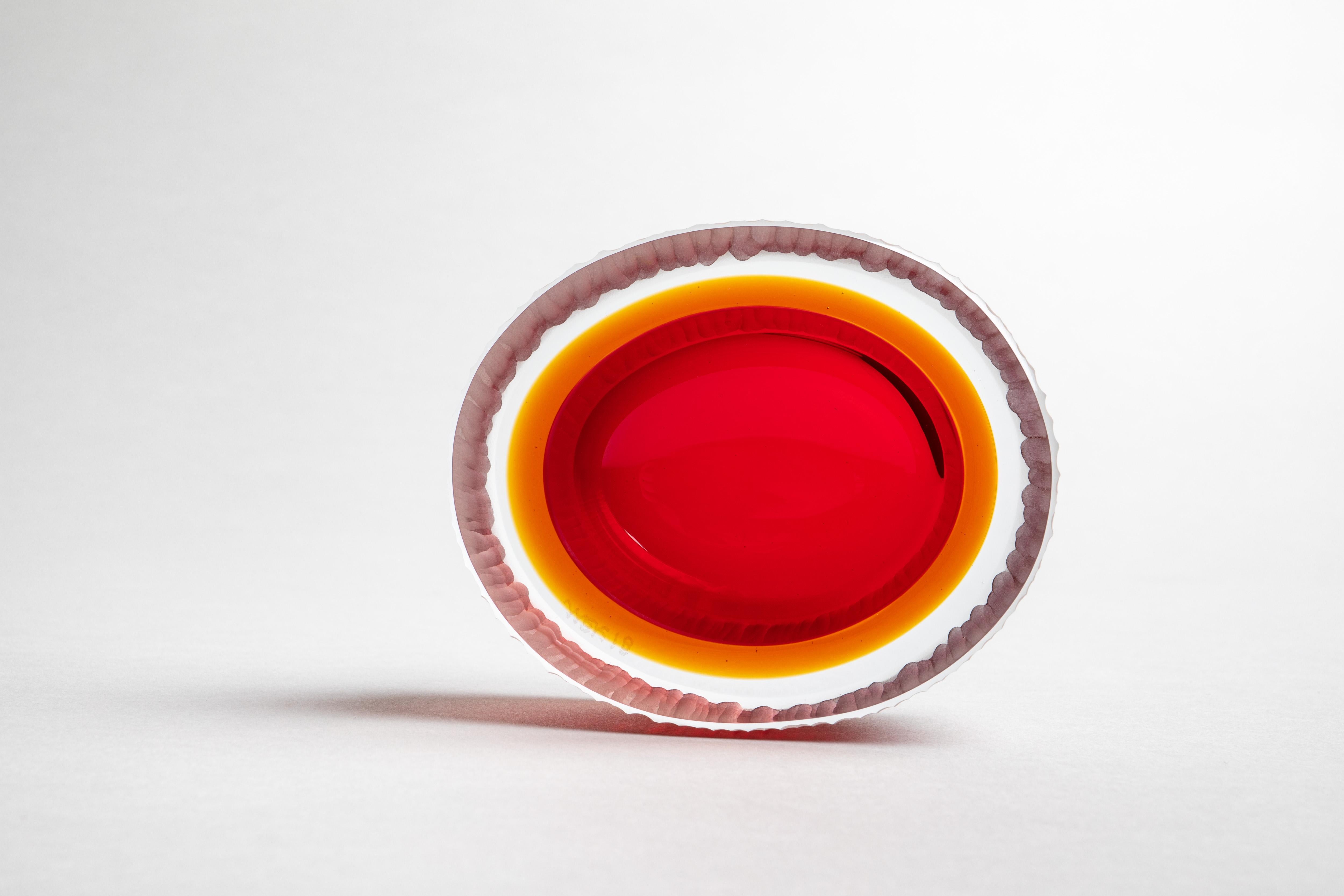 A small yet solid object with a strong presence, the Kasa Mignon is skillfully crafted by a glass master using a technique involving the layering of cristallo glass to a core of intense color. Once cooled the blown glass body is cut in half, hand