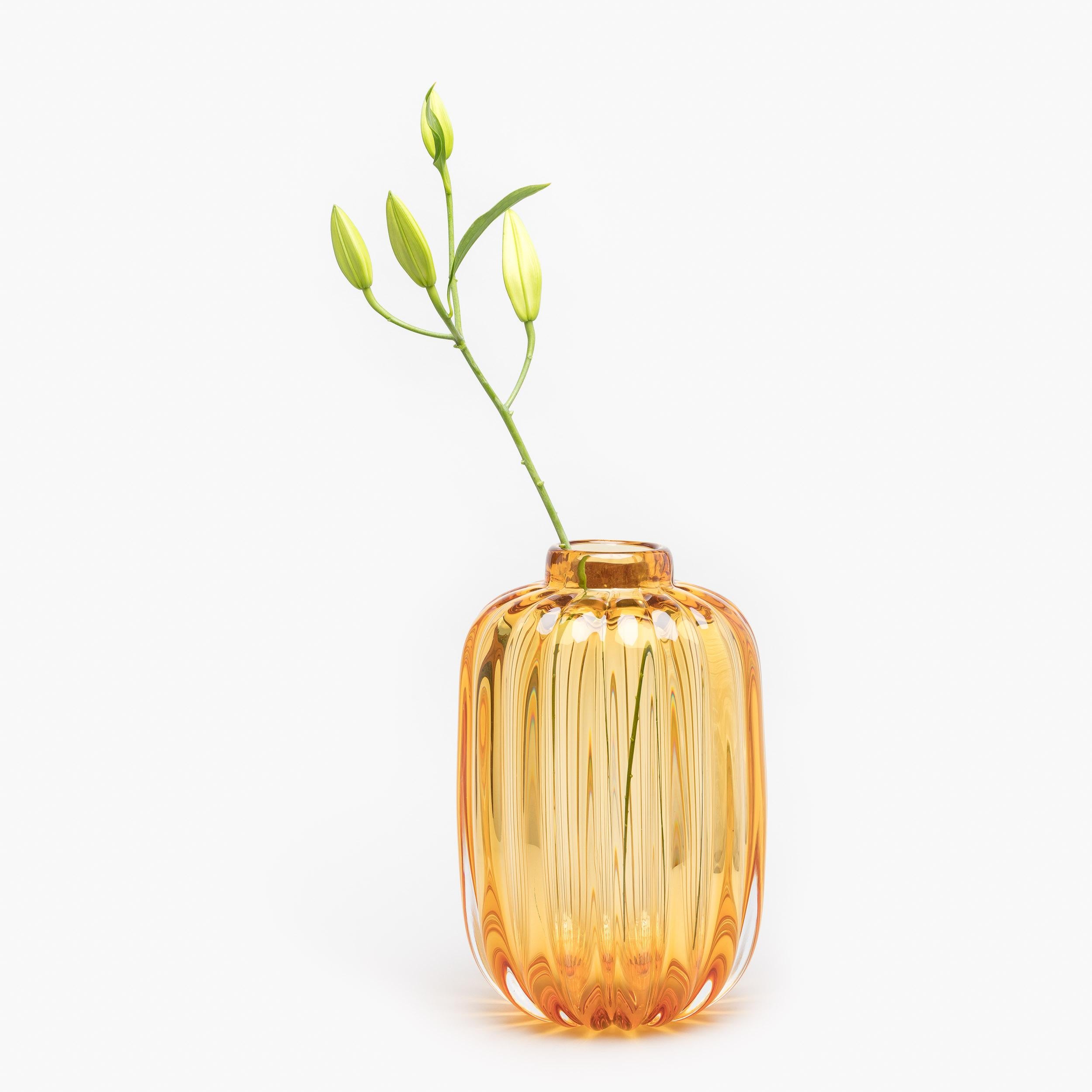 Inspired by the shape and proportions of vintage storage jars, the Fiori Jar vase requires many strong and skilful hands to produce. A heavy portion of molten glass is worked into shape before being mouth blown into an iron mold to produce