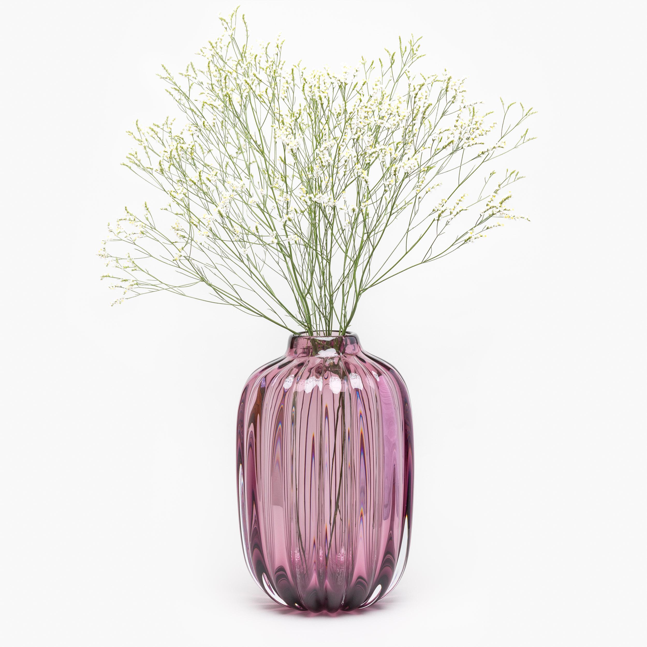 Inspired by the shape and proportions of vintage storage jars, the Fiori Jar vase requires many strong and skillful hands to produce. A heavy portion of molten glass is worked into shape before being mouth blown into an iron mold to produce