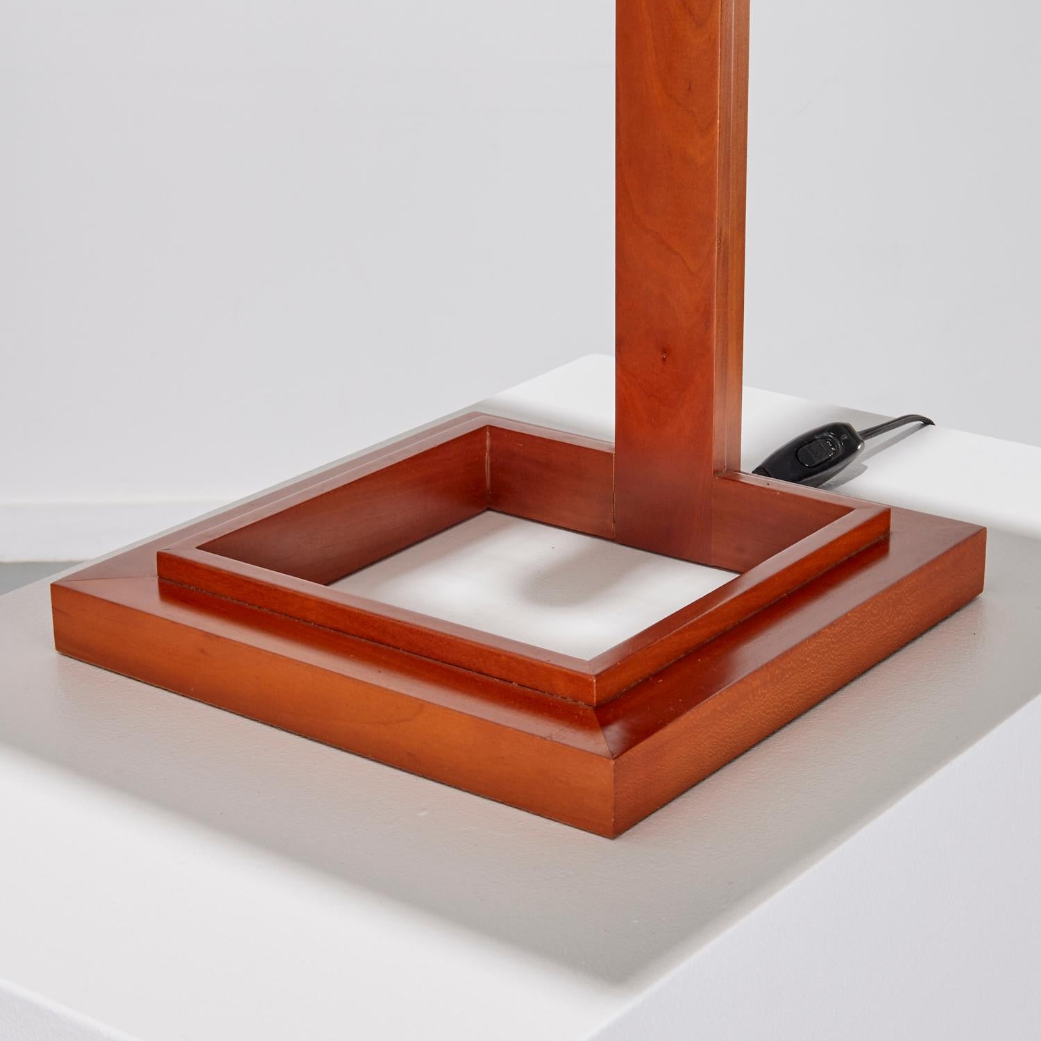 Circa 1990s, Japan, a Frank Lloyd Wright designed Taliesin table lamp in cherry wood with a synthetic parchment shade.  Model s2307 - a metal label to the underside with Frank Lloyd Wright facsimile signature.

The Taliesin lamp was designed for