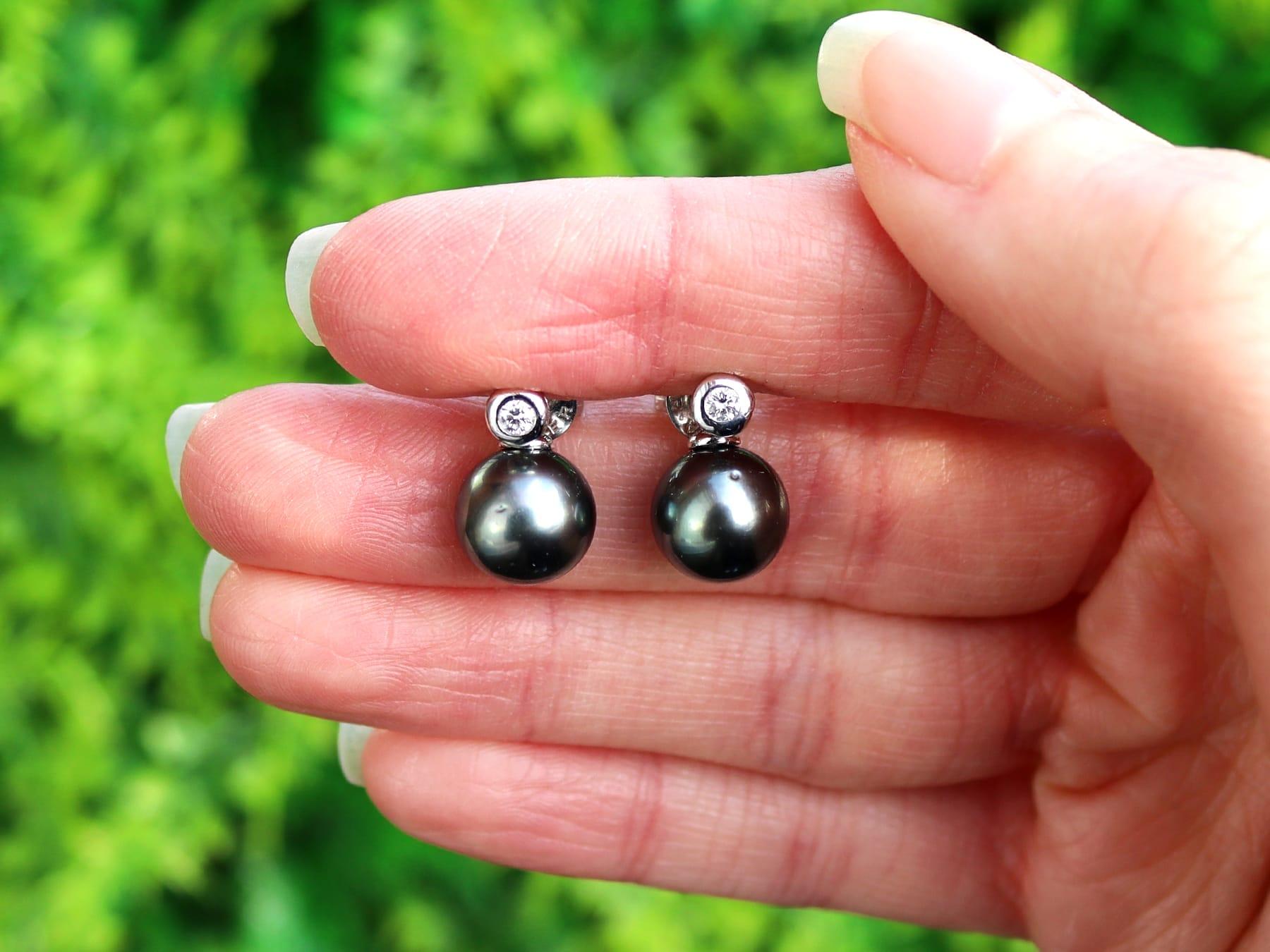 An impressive pair of black pearl and 0.08 carat diamond, 14 karat white gold earrings by Yana Nesper; part of our diverse pearl jewelry and estate jewelry collections.

These fine and impressive black pearl earrings with diamonds have been crafted