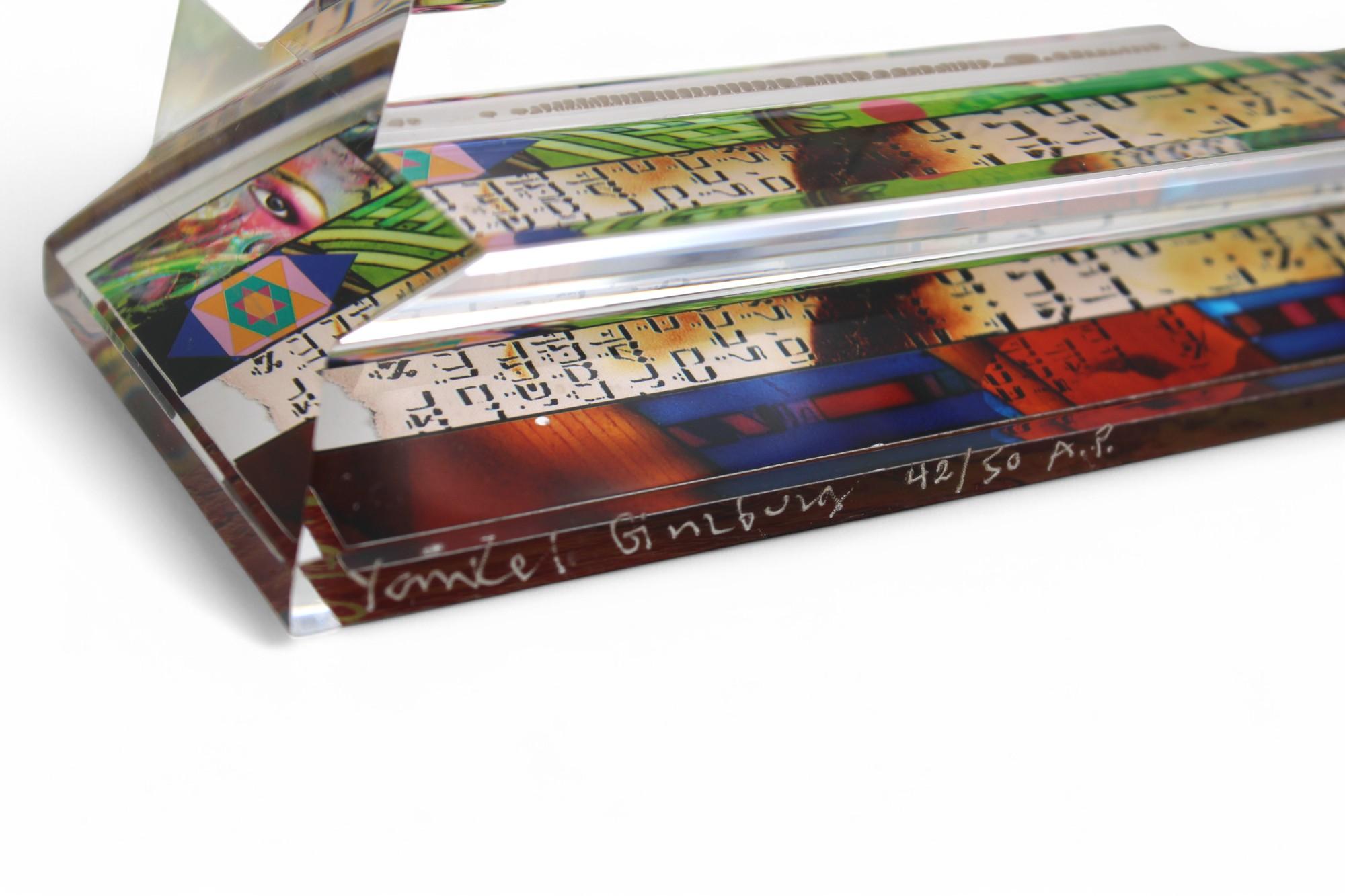 A stunning and rare artist proof (42/50) by renowned artist Yankel Ginzburg, this acrylic lucite mezuzah is a mesmerizing fusion of tradition and contemporary artistry. The sculptural design features vibrant screen-printed Hebrew characters and
