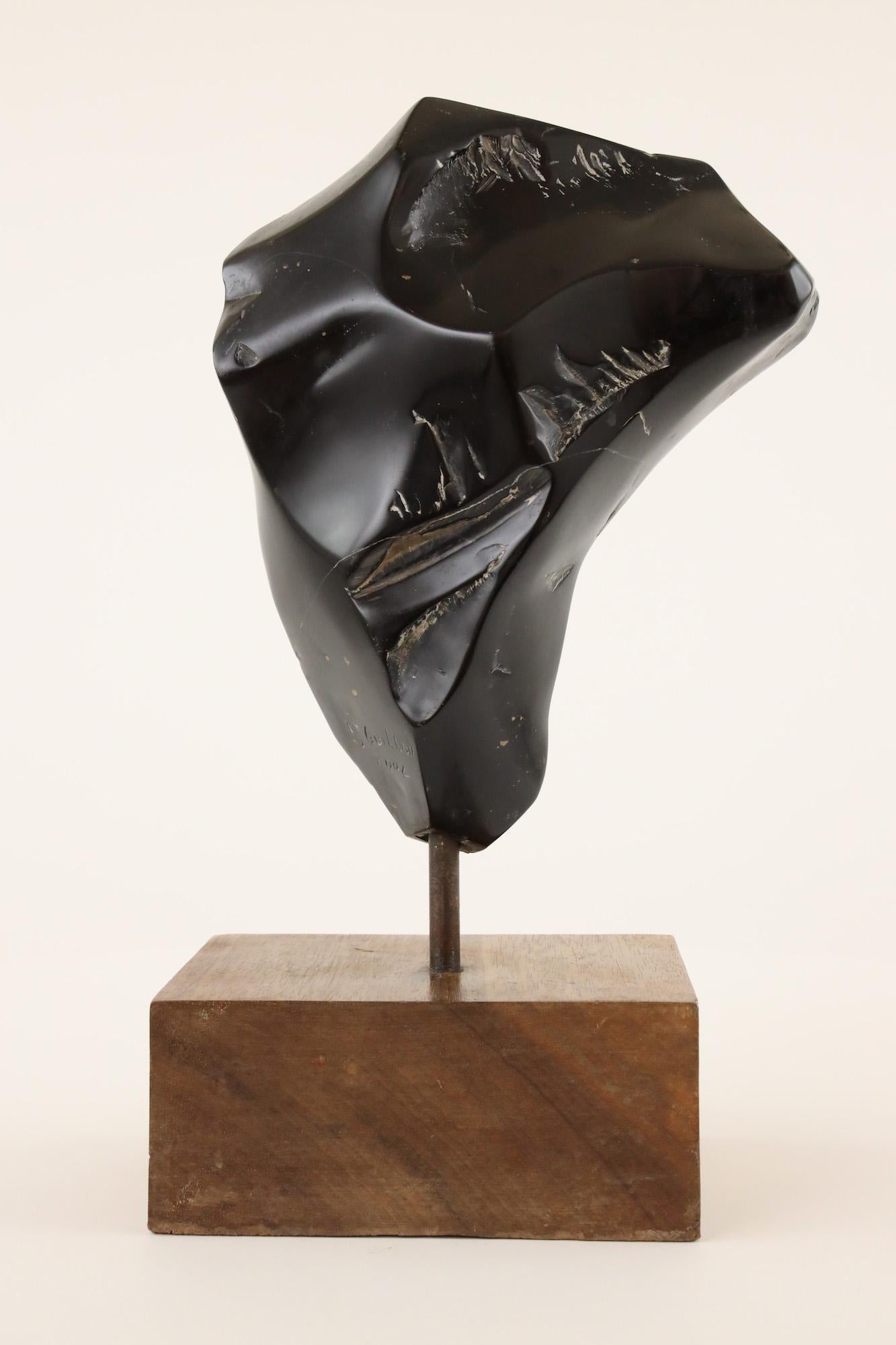 Unique work. Belgian black marble sculpture. Sold with wooden base 
Dimensions of the sculpture: 25 H x 21 L x 9 D cm
Total height of the sculpture with the base and shaft: 37 cm