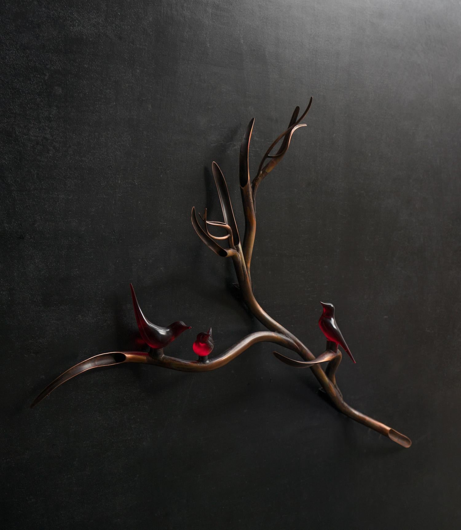 This charming conversation piece is designed for wall mounting and is a copper branch fitted with red opaque birds.

Hussein's work always combines the true sense of material with ethereal beauty as though the piece has been drawn, the fluidity