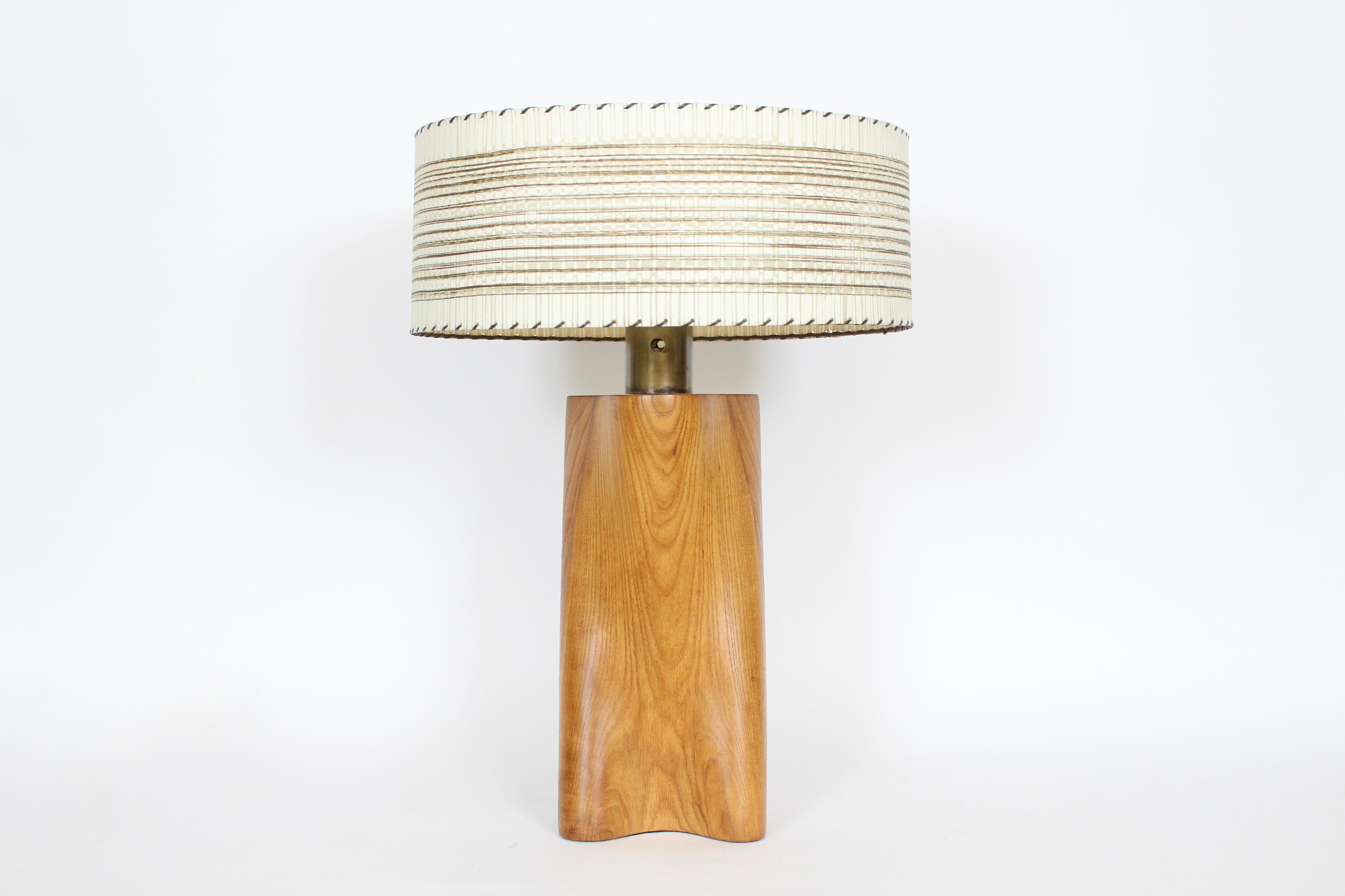 Early Organic Modern Yasha Heifetz solid Ash, Brass & Glass Table Lamp. Featuring a handcrafted solid smooth sculpted ash biomorphic form with wide cylindrical brass neck and white milk glass liner shade. 21H to top of socket. 16H to top of Wood.