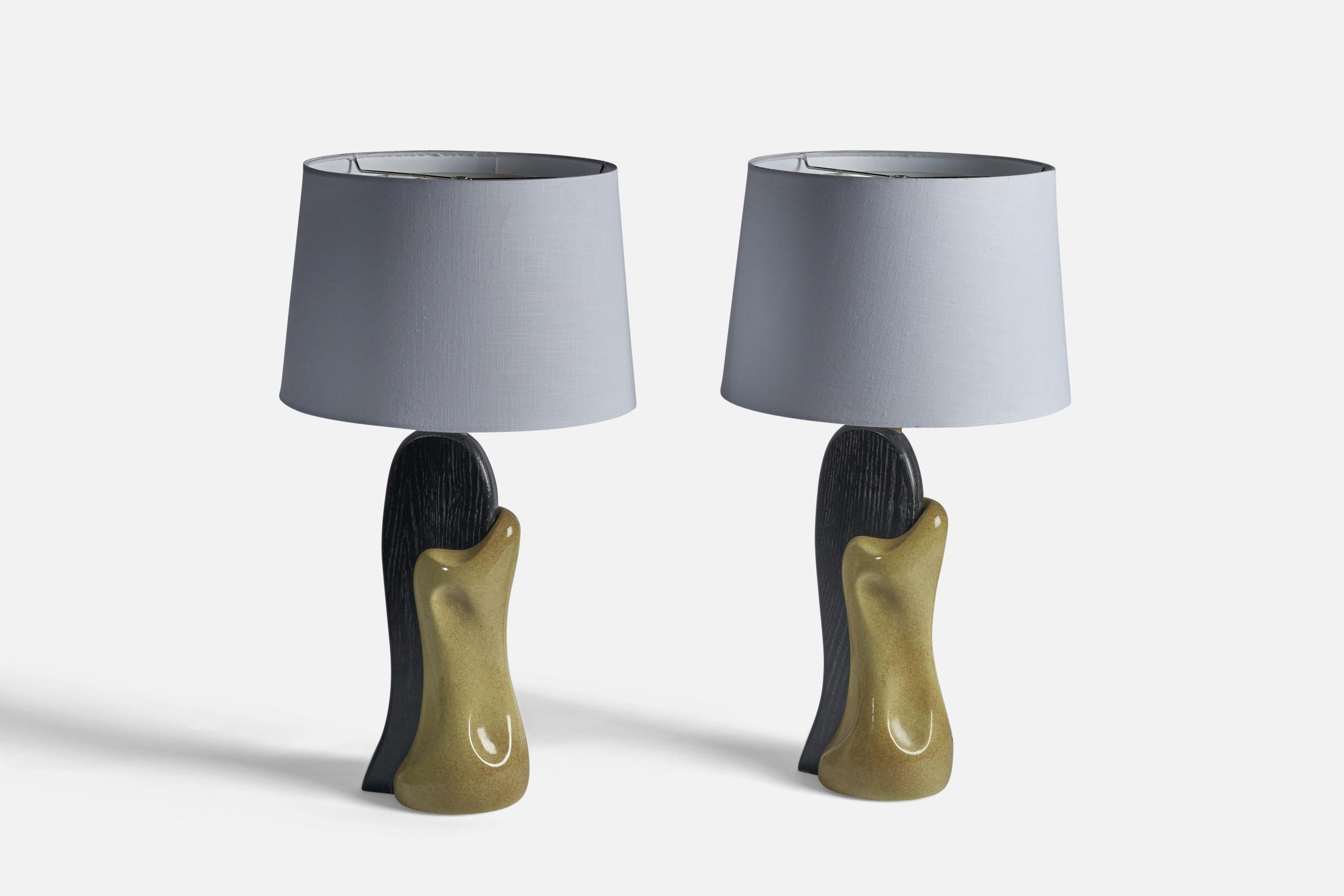 A pair of black-cerused oak and yellow-glazed ceramic table lamps, designed and produced by Yasha Heifetz, USA, 1950s.

Dimensions of Lamp (inches): 26.75
