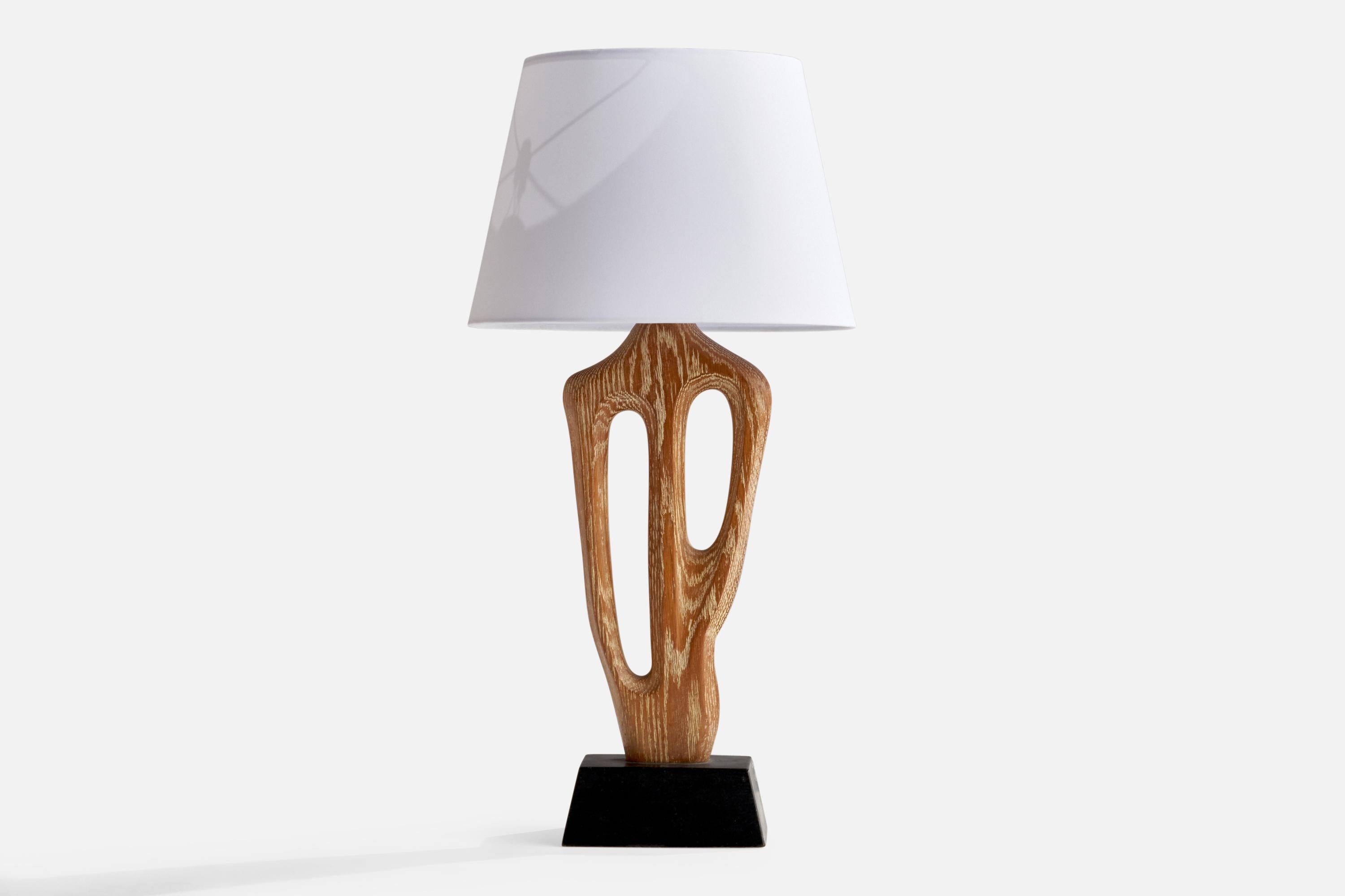 A cerused and black-painted oak table lamp designed and produced by Yasha Heifetz, USA, 1950s.

Overall Dimensions (inches): 29”  H x 14” W x 5.5” D
Stated dimensions include shade.
Bulb Specifications: E-26 Bulb
Number of Sockets: 1
All lighting