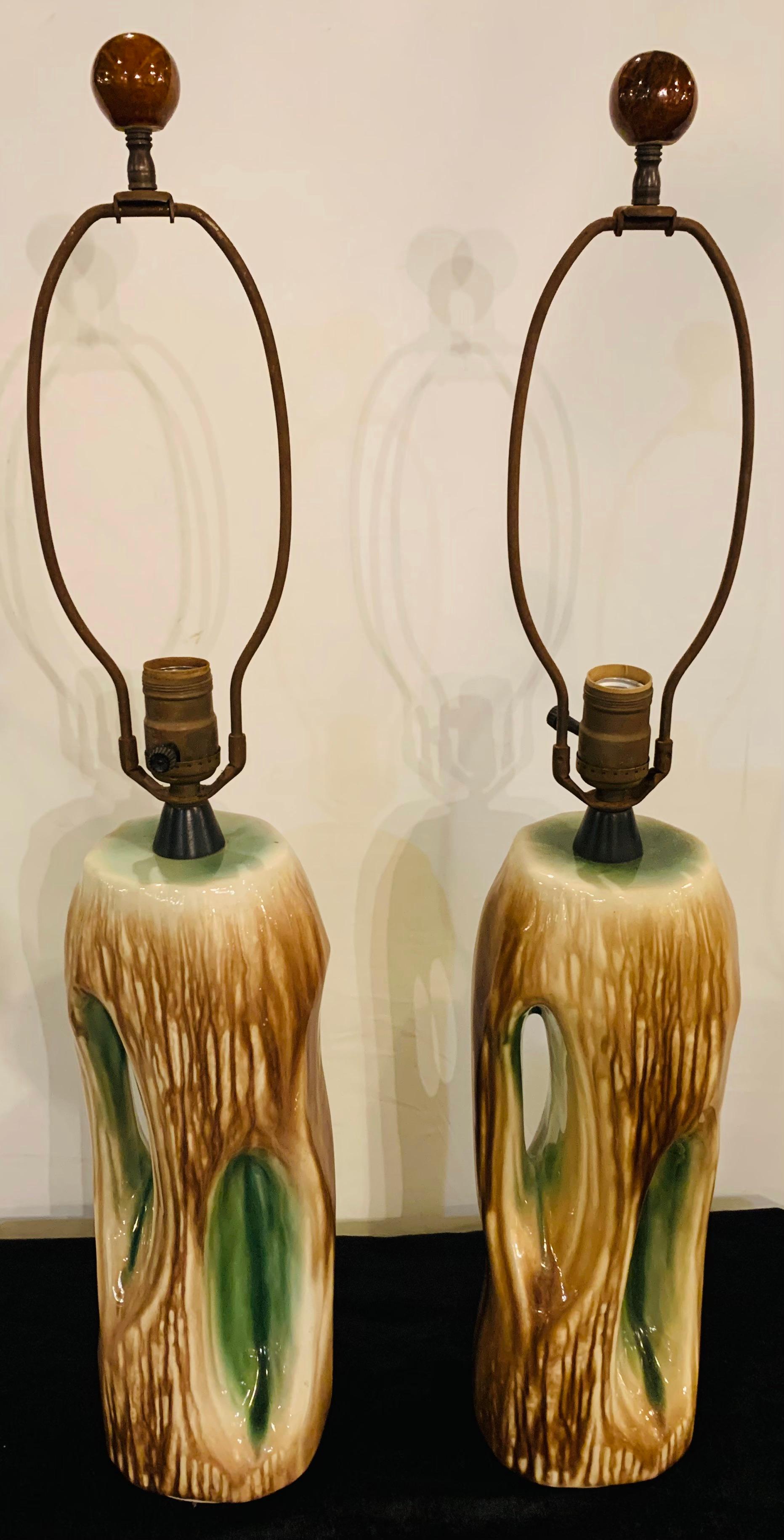 Mid-Century Modern ceramic tree trunk table lamp, a pair

This pair of fine Yasha Heifetz ceramic Mid-Century Modern table lamps features green and brown tones on tree trunk shaped base. The pair of lamps is signed by the designer. This pair is