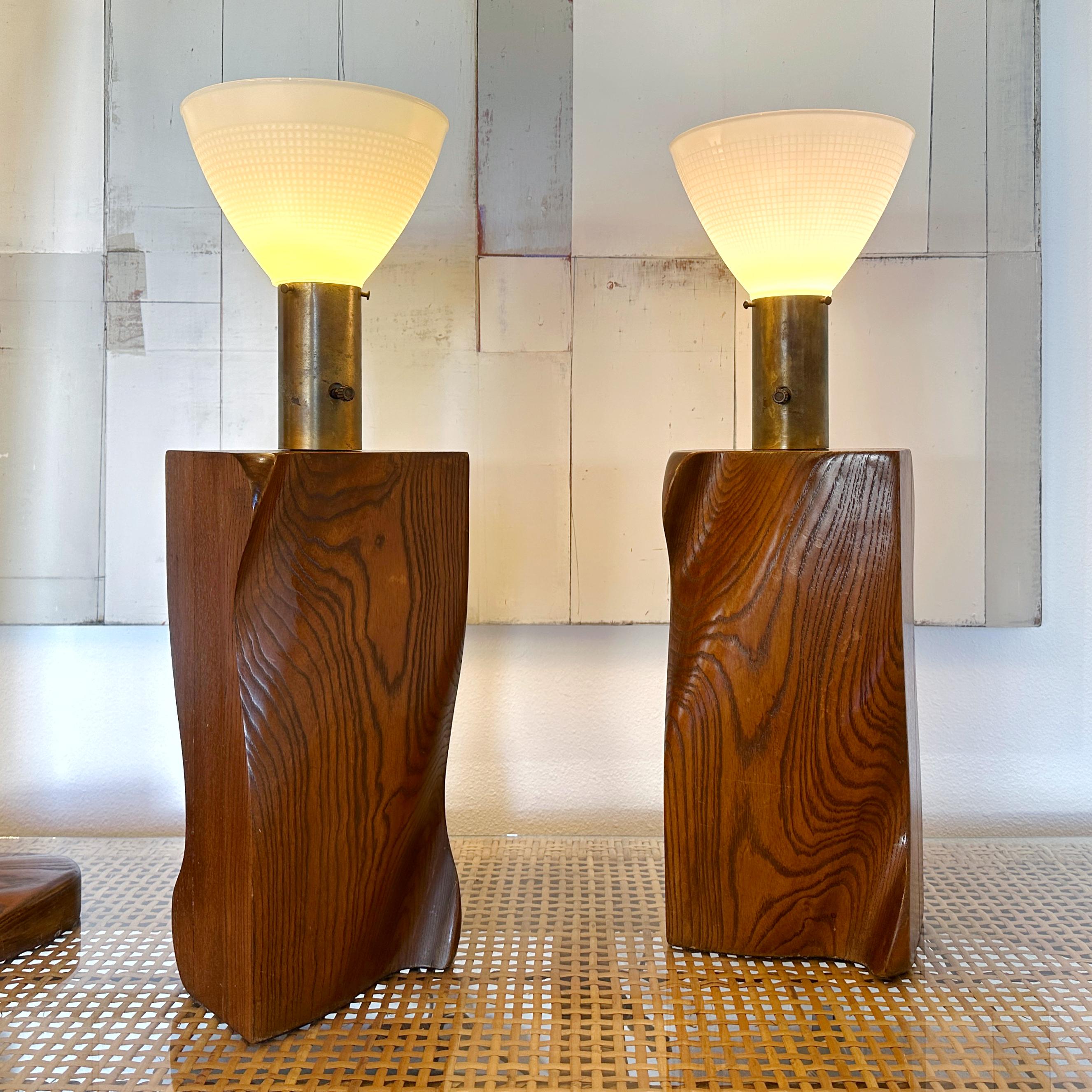 This is a fabulous pair of biomorphic sculpted walnut table lamps with milk glass shades attributed to Yasha Heifetz for The Heifetz Company of New York. The lamps were likely designed in the late 40s but were popular through the mid 1950s. These