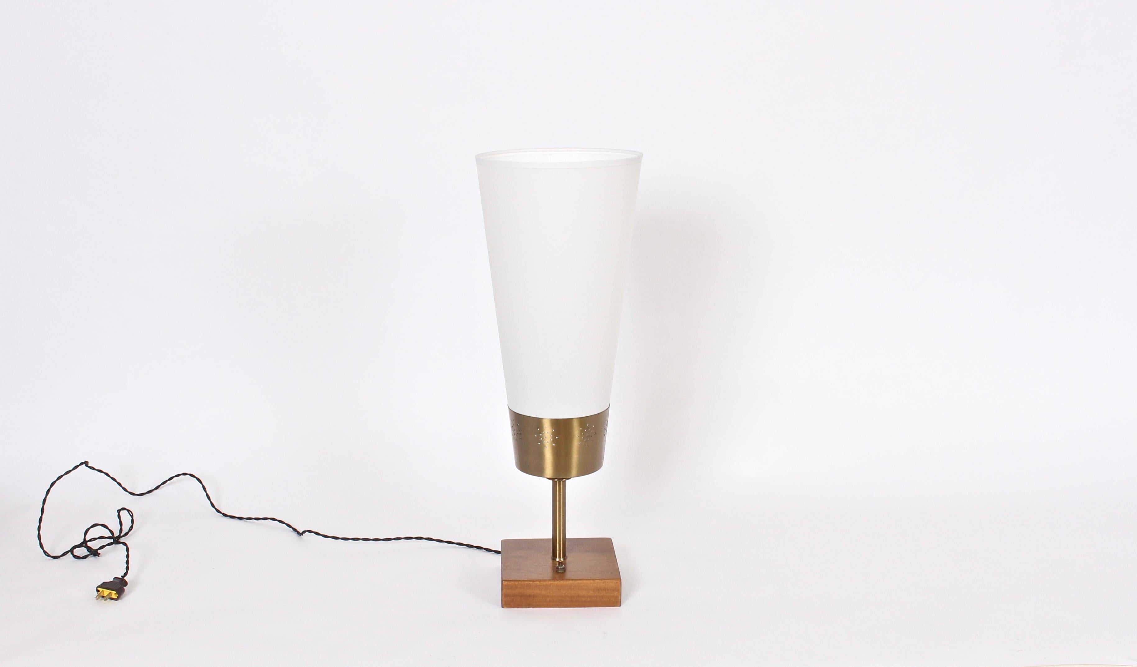 Yasha Heifetz mahogany, brass and parchment table lamp, 1940s. Featuring a round pierced illuminating brass container, newly recovered cone parchment shade (16 H x 4.5 D top x 8 D bottom) on a square refinished mahogany base. Rewired with black
