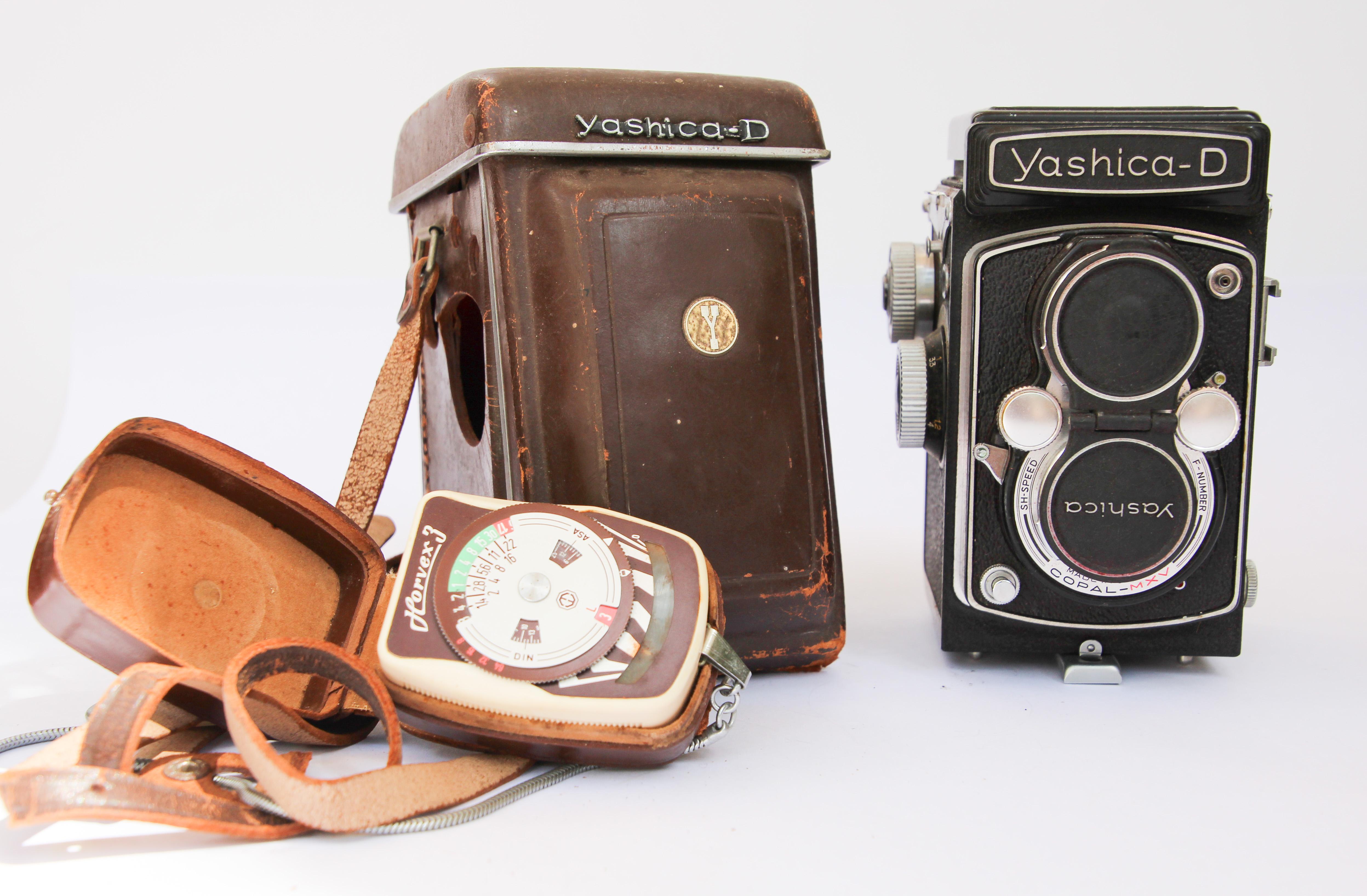 The Yashica D was manufactured between 1958 and 1972, it’s a pretty standard Twin Lens Reflex (TLR) camera that takes 120 film and creates 6×6 images.
Early models (which is what mine is), featured 80mm f/3.5, 3-element Yashikkor viewing and taking