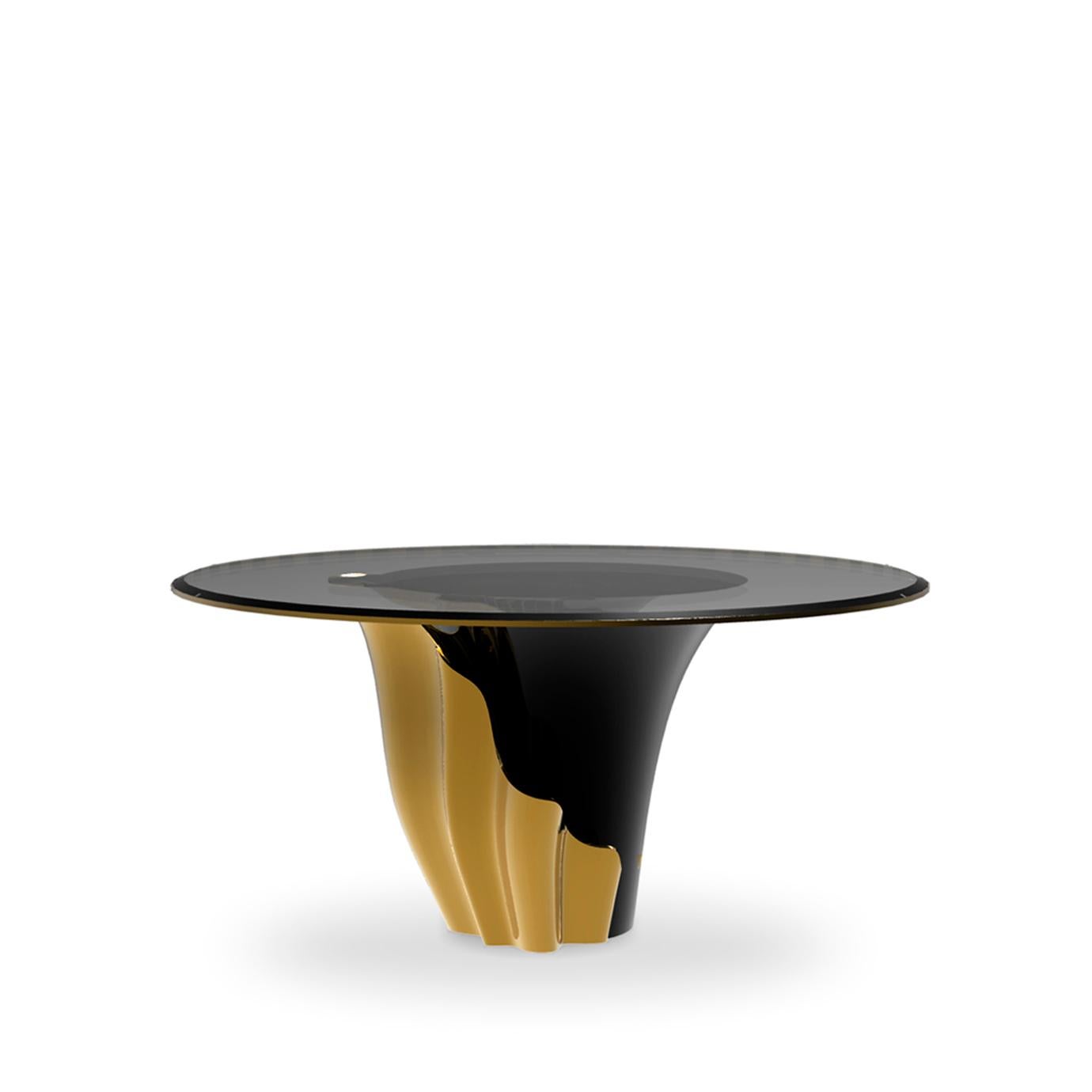 A central piece to any space, the contemporary design of the Yasmine dining table will have everyone doing double takes. The sultry silhouette is fashioned from tailored glass and mounted on a solid wooden base. Classic lacquer and luxurious plated