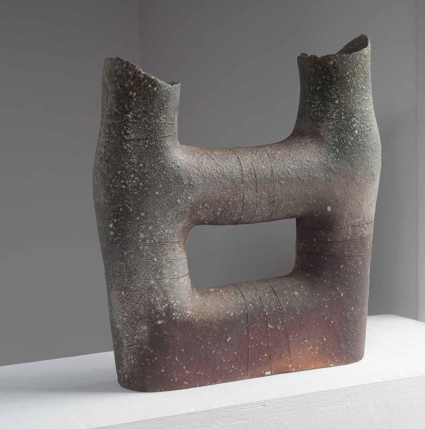 Yasuhisa Kohyama shapes his asymmetrical forms using piano wire, creating distinctive rough surfaces. The clay with its feldspar nuggets creates a tactile quality rarely seen in contemporary work. No glaze is used, but the wood ash and placement in