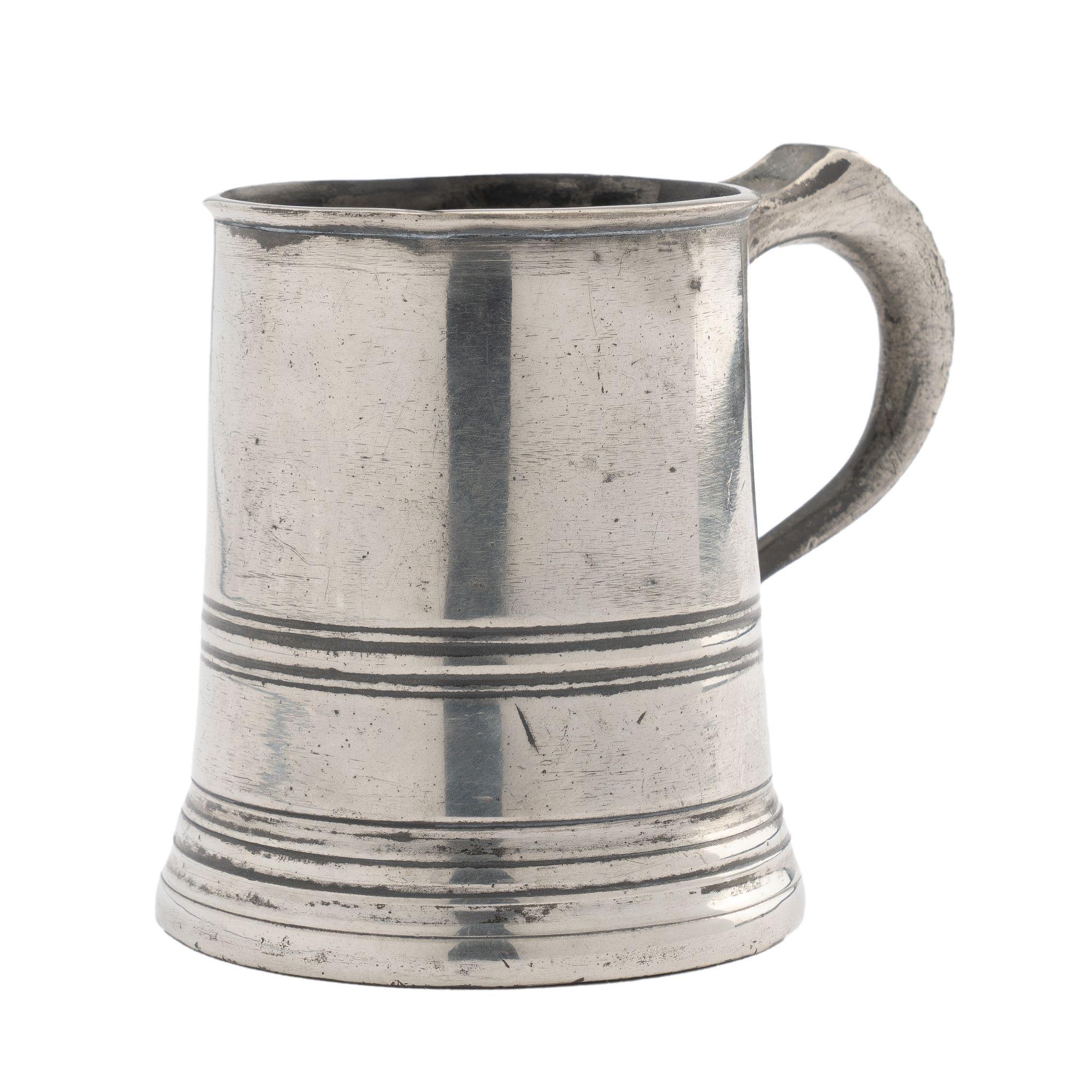 Half pint pewter mug by Yates & Birch. The tapered mug has a beaded lip, inscribed beading at the middle and base of the mug, and an applied handle. Stamped on the underside of the lip: Yates & Birch, 1/2 (Pint)

Birmingham, England, 1839-1860.