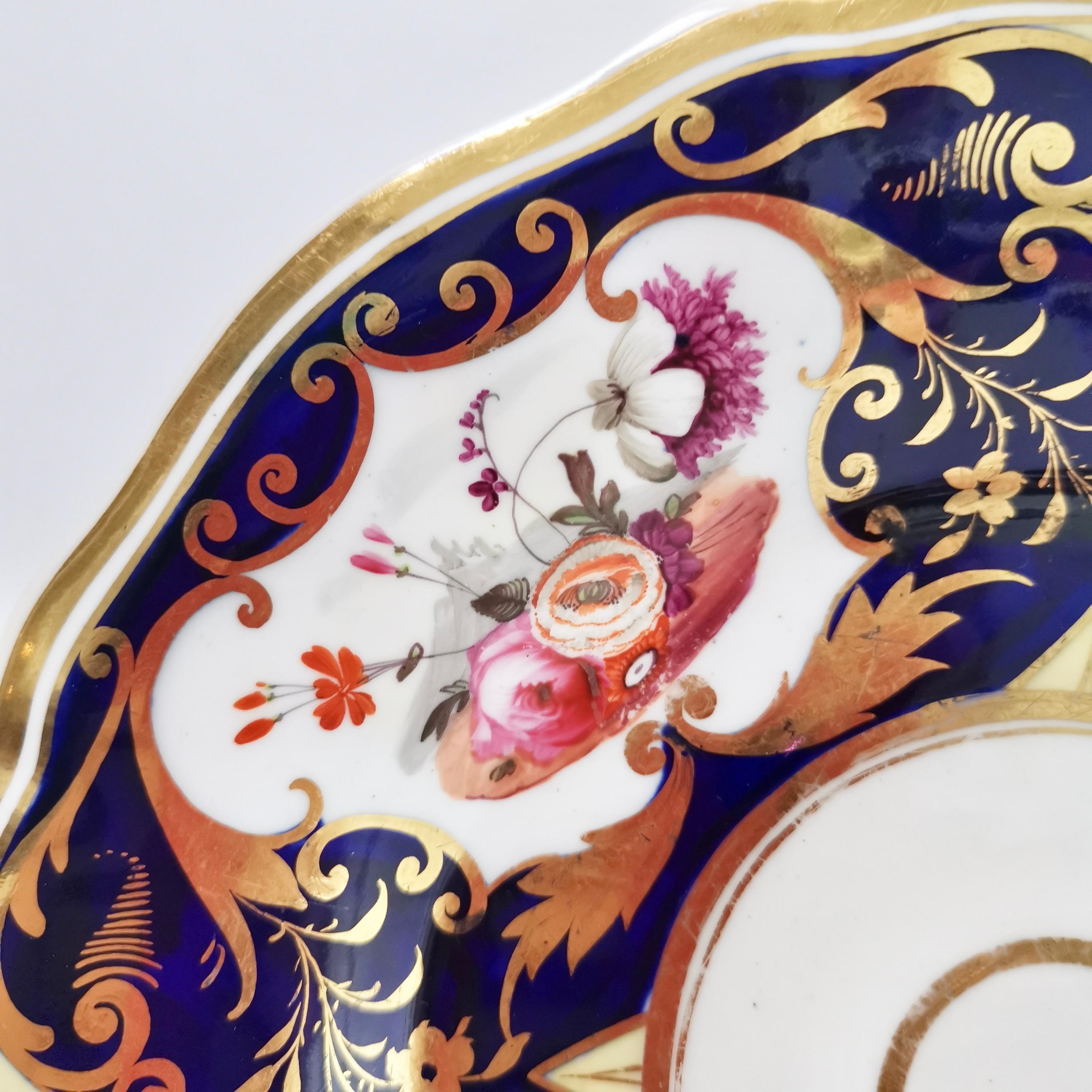 This is a beautiful plate made by Yates in about 1826, which is known as the Regency period. It is decorated with a striking pattern in cobalt blue, gilt and hand painted flowers.
 
The Yates factory was operative between 1784 and 1836 and was
