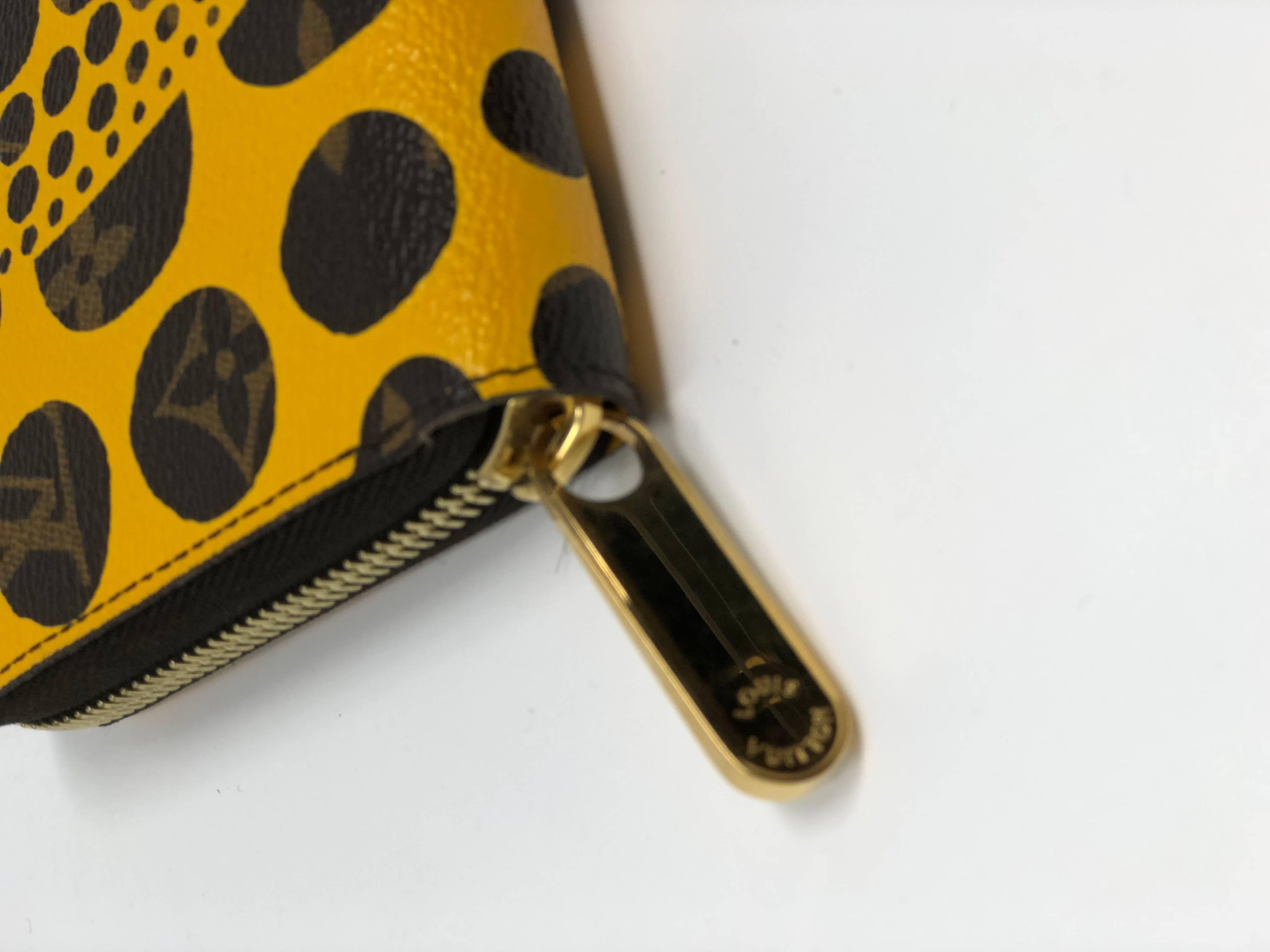 Pumpkin dots by Yayoi Kusama collection zippy wallet clutch in yellow. Mint condition with box. 