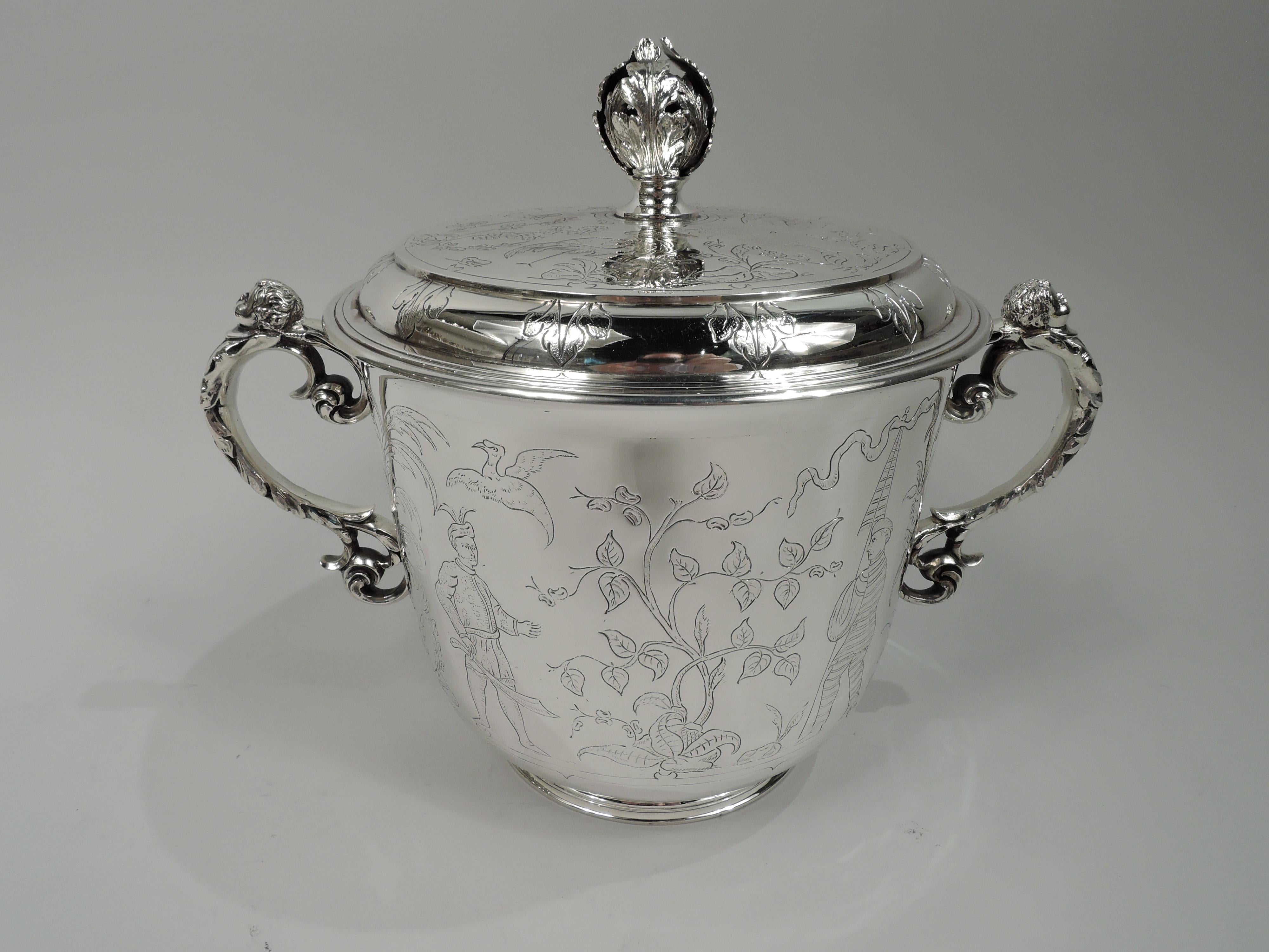 George V sterling silver ice bucket. Made by Charles & Richard Comyns in London in 1925. Urn with curved bottom and raised and inset foot. Leaf-wrapped s-scroll side handles with cherub cap in form of chubby-cheeked, curly haired boy. Cover raised