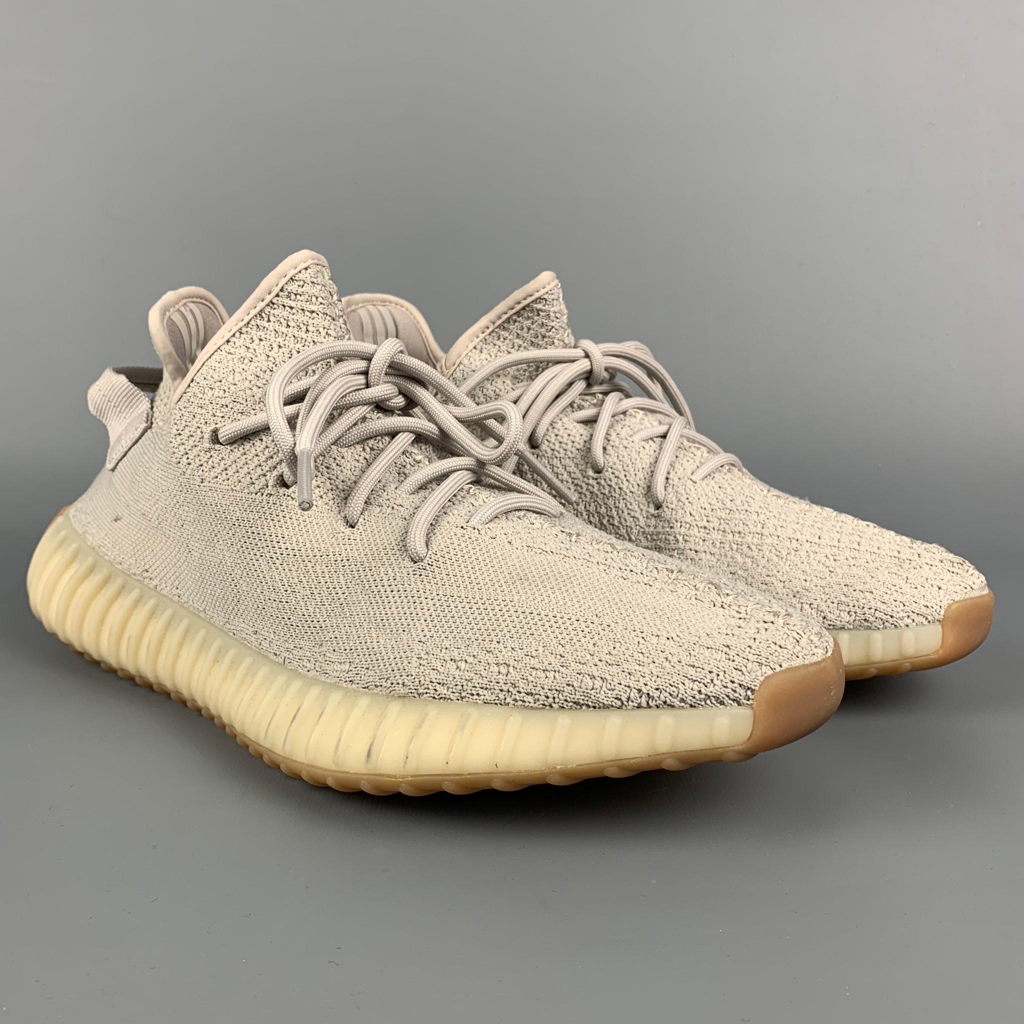 YEEZY x ADIDAS Boost 350 sneakers comes in a light grey knit material featuring a rubber sole and a lace up closure. 

Very Good Pre-Owned Condition.
Marked: 11.5
 
Outsole: 12.5 in. x 5 in. 