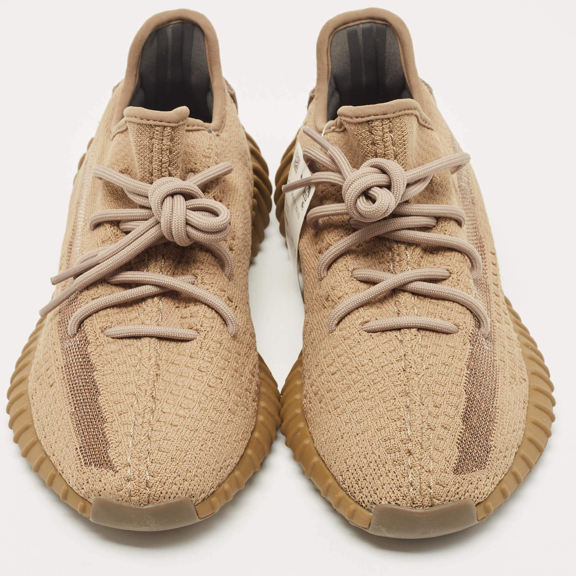 The Yeezy x Adidas Boost 350 V2 Earth sneakers are stylish and comfortable footwear. They feature a blend of brown mesh and fabric in their construction, with signature Boost technology for exceptional cushioning. The design showcases the brand's