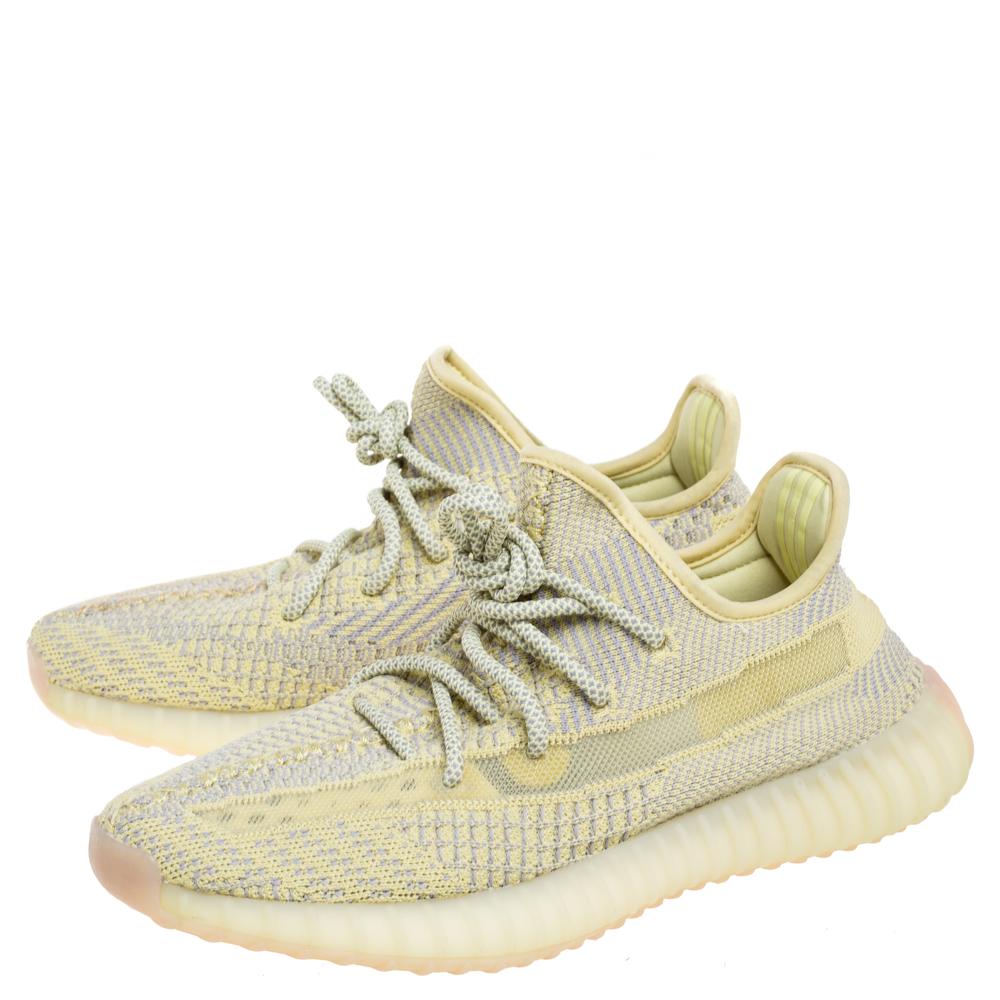The Yeezy adidas 350 V2 Antlia sneakers made from Primeknit feature an upper in canary yellow and soft grey. They have the signature translucent side stripe but are without the heel tab—an update that gives the Antlia a cleaner look.

