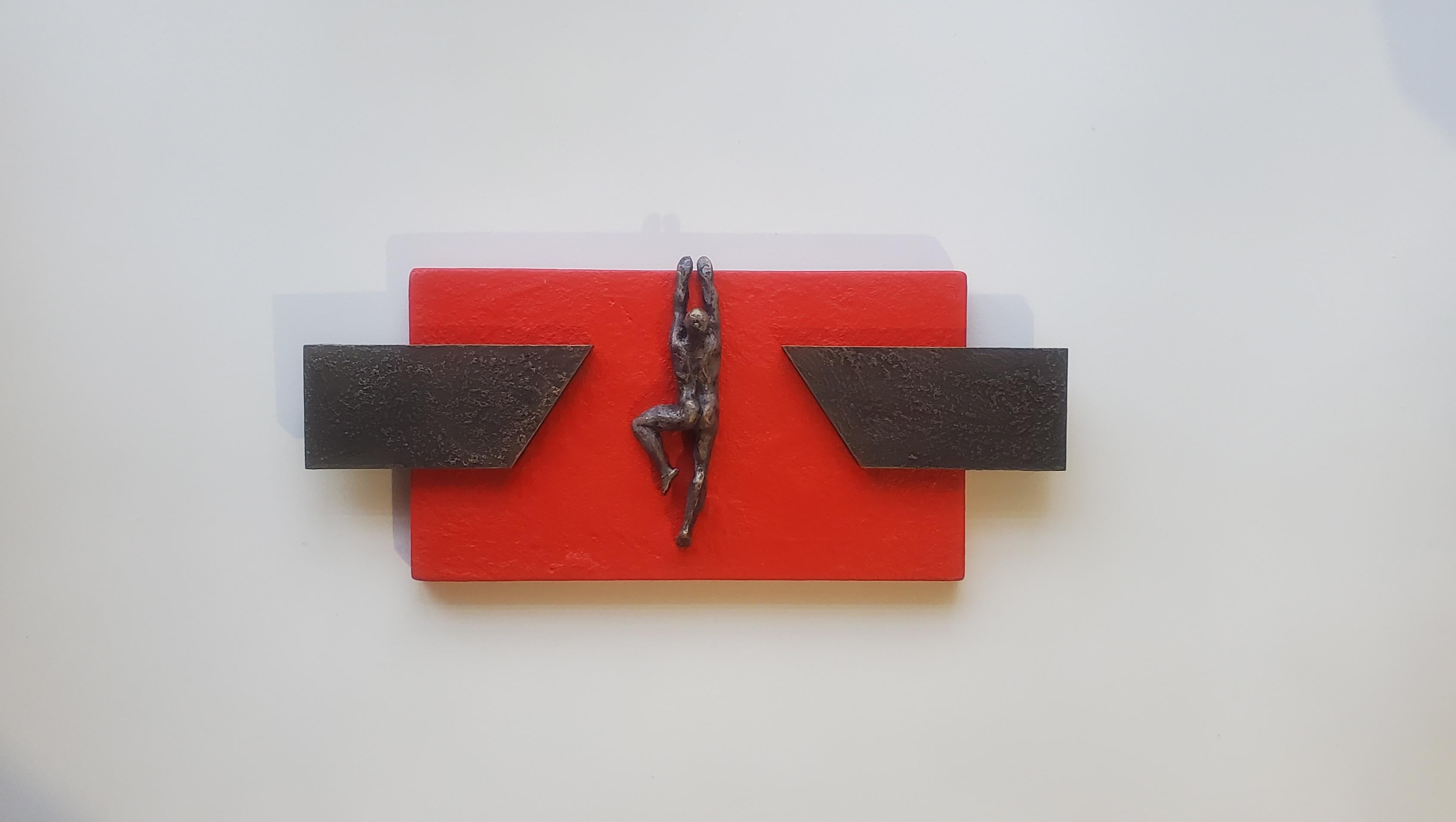 <p>Artist Comments<br />A small resin figure, painted to resemble bronze, climbs on a red wooden base. The bars on each side provide stability and balance. Artist Yelitza Diaz notes that humans are natural creators. We are continuously advancing and