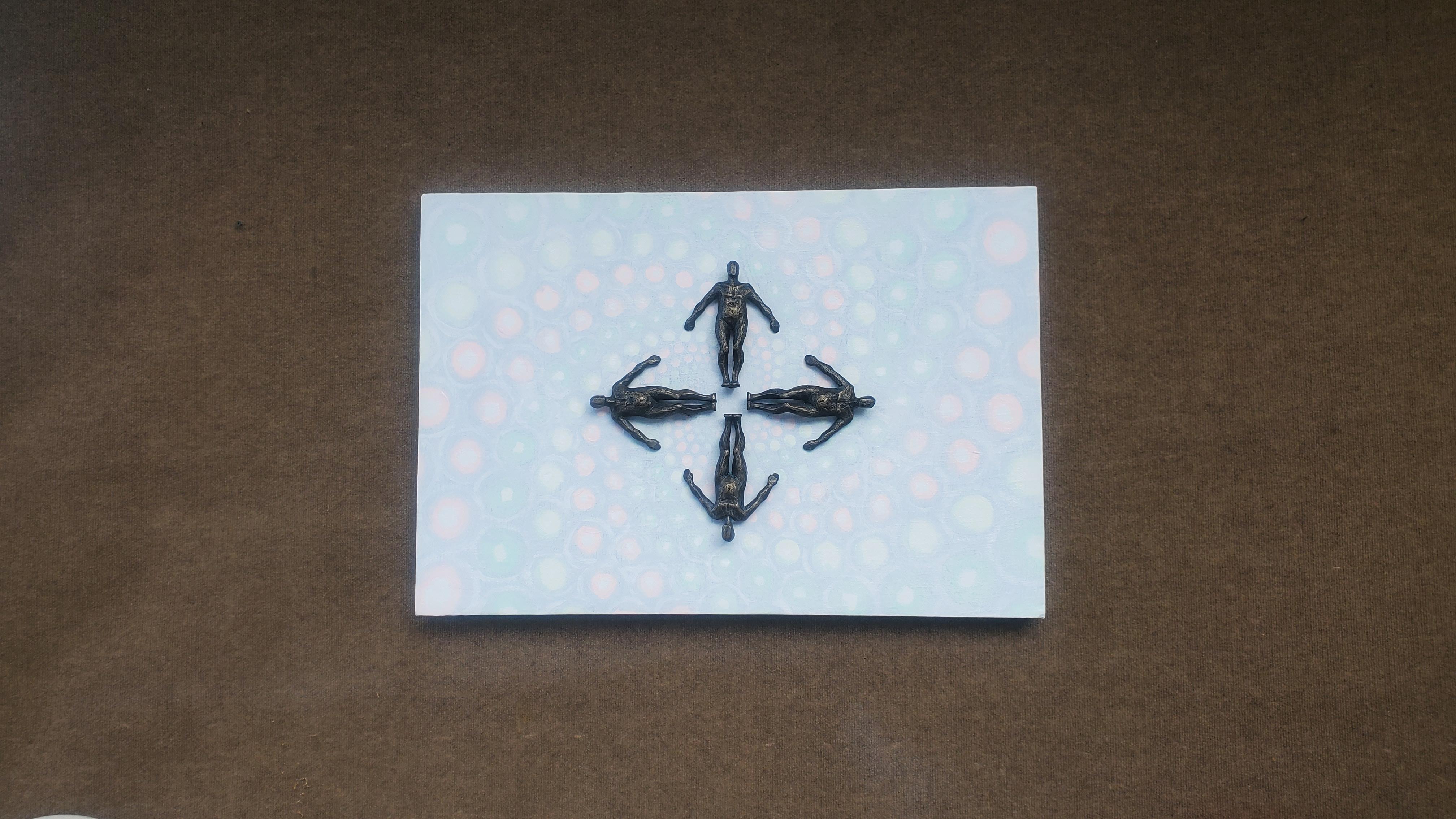 <p>Artist Comments<br />Four figures lie in a symmetrical cross formation, their dark metallic bodies contrasting with a soft background. Pastel spirals resembling cosmic mist float behind them. The artwork represents the connection between humans