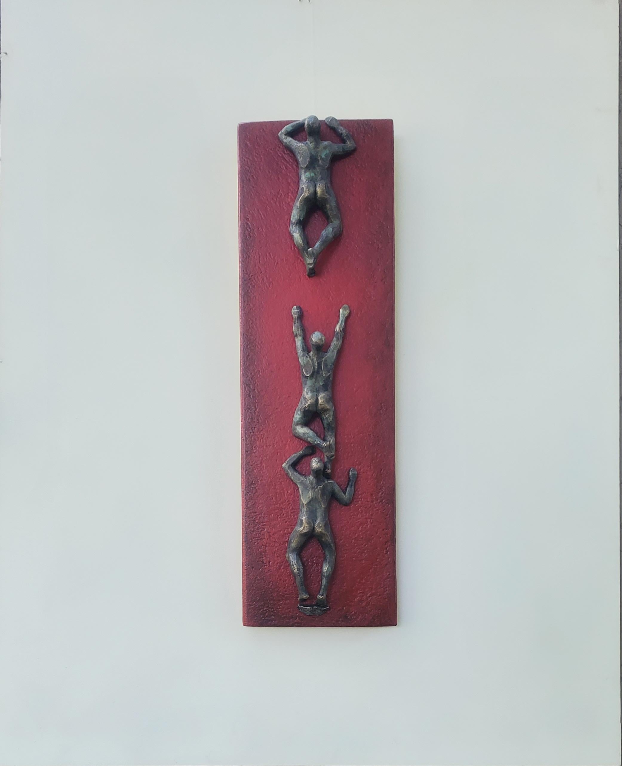 <p>Artist Comments<br>Artist Yelitza Diaz combines figurative art and geometric elements with three nude figures climbing a vertical red panel. Rooted in the idea of conquering obstacles and breaking through barriers, the work symbolizes the pursuit