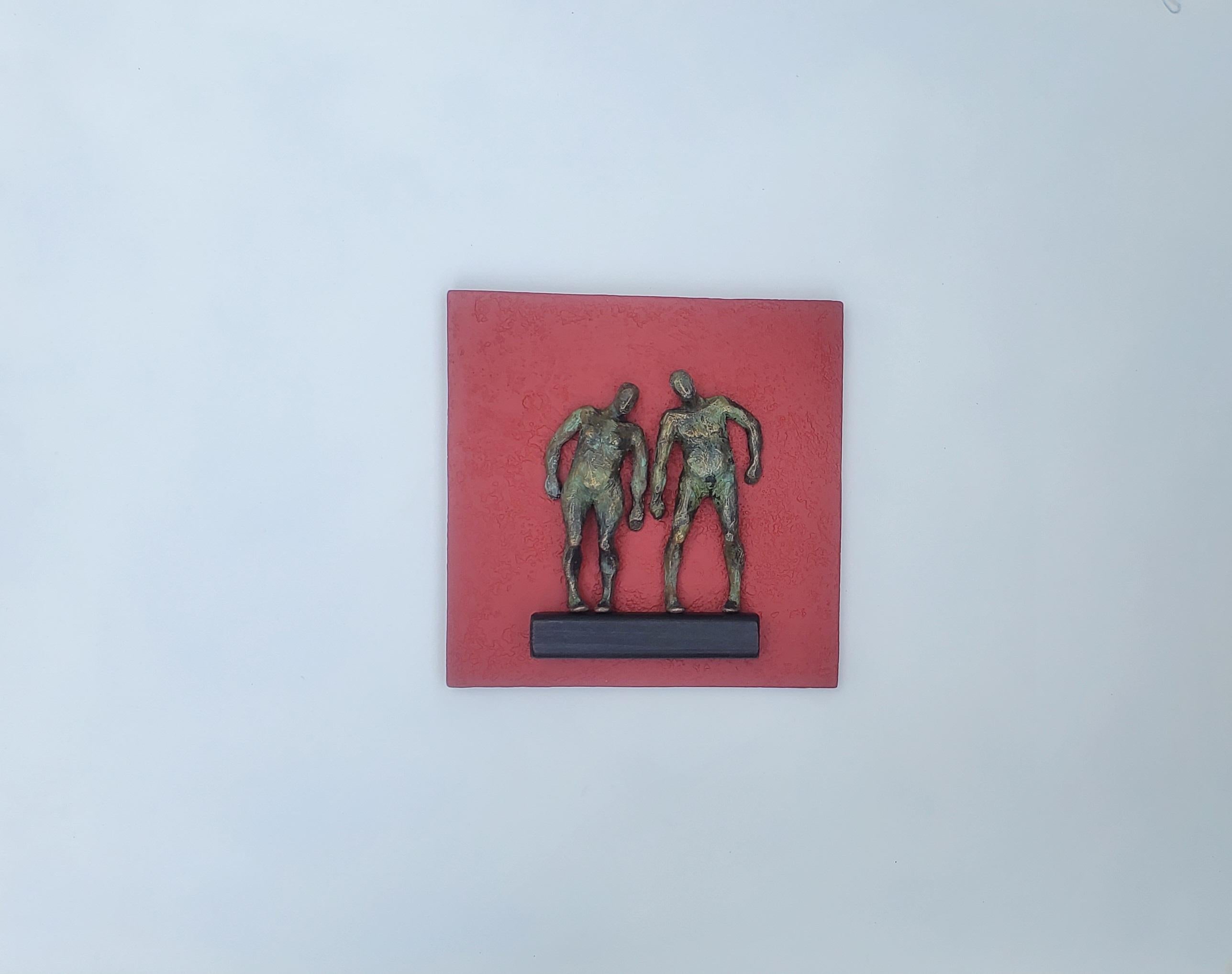 <p>Artist Comments<br />Artist Yelitza Diaz demonstrates two bronze-colored nude figures standing on a narrow ledge. 