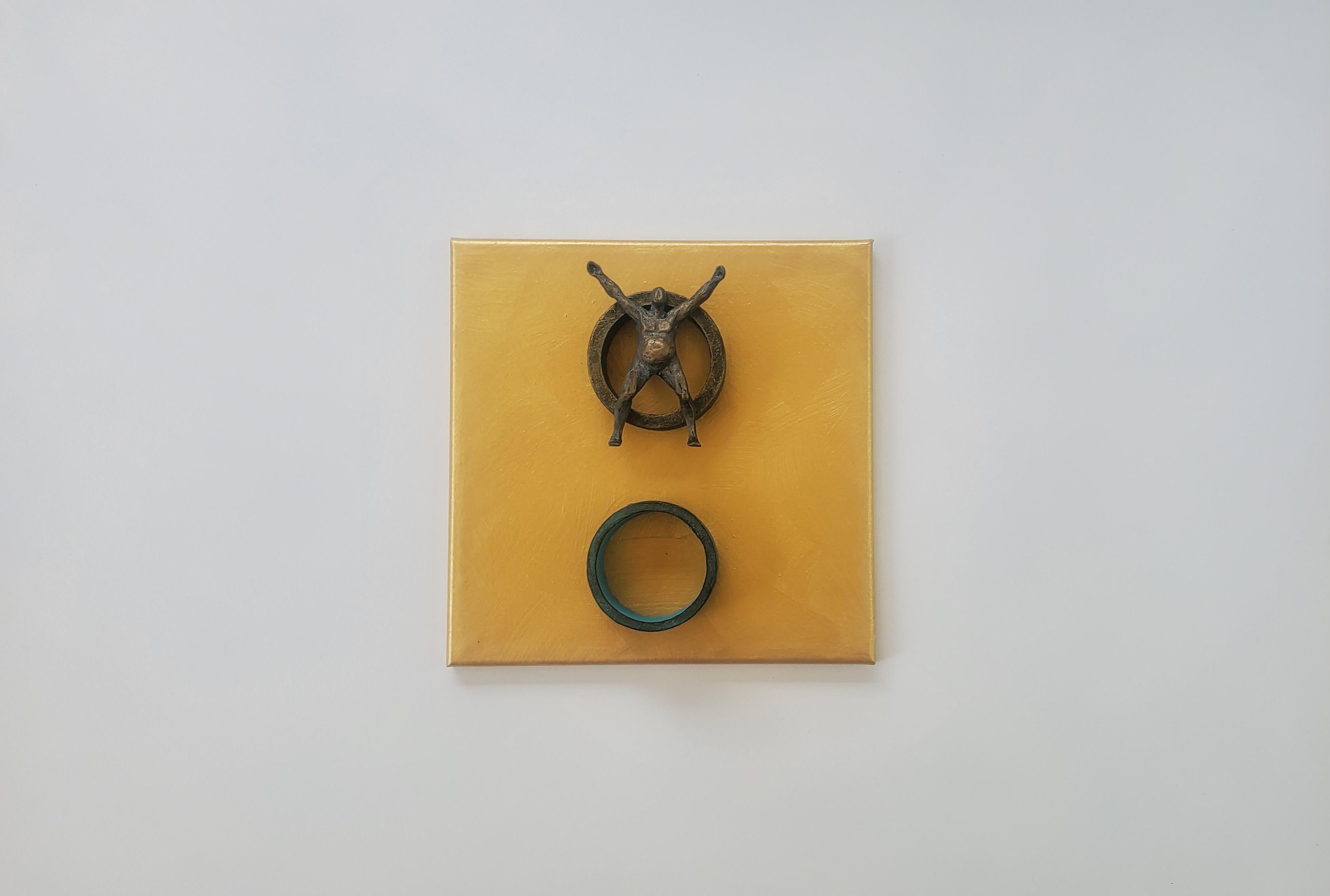 <p>Artist Comments<br>Artist Yelitza Diaz shares a bronze-colored figure on a circular cardboard, resin, and wood structure. She intersects modern and minimalist approaches by imposing human figures on 3D geometric elements. 