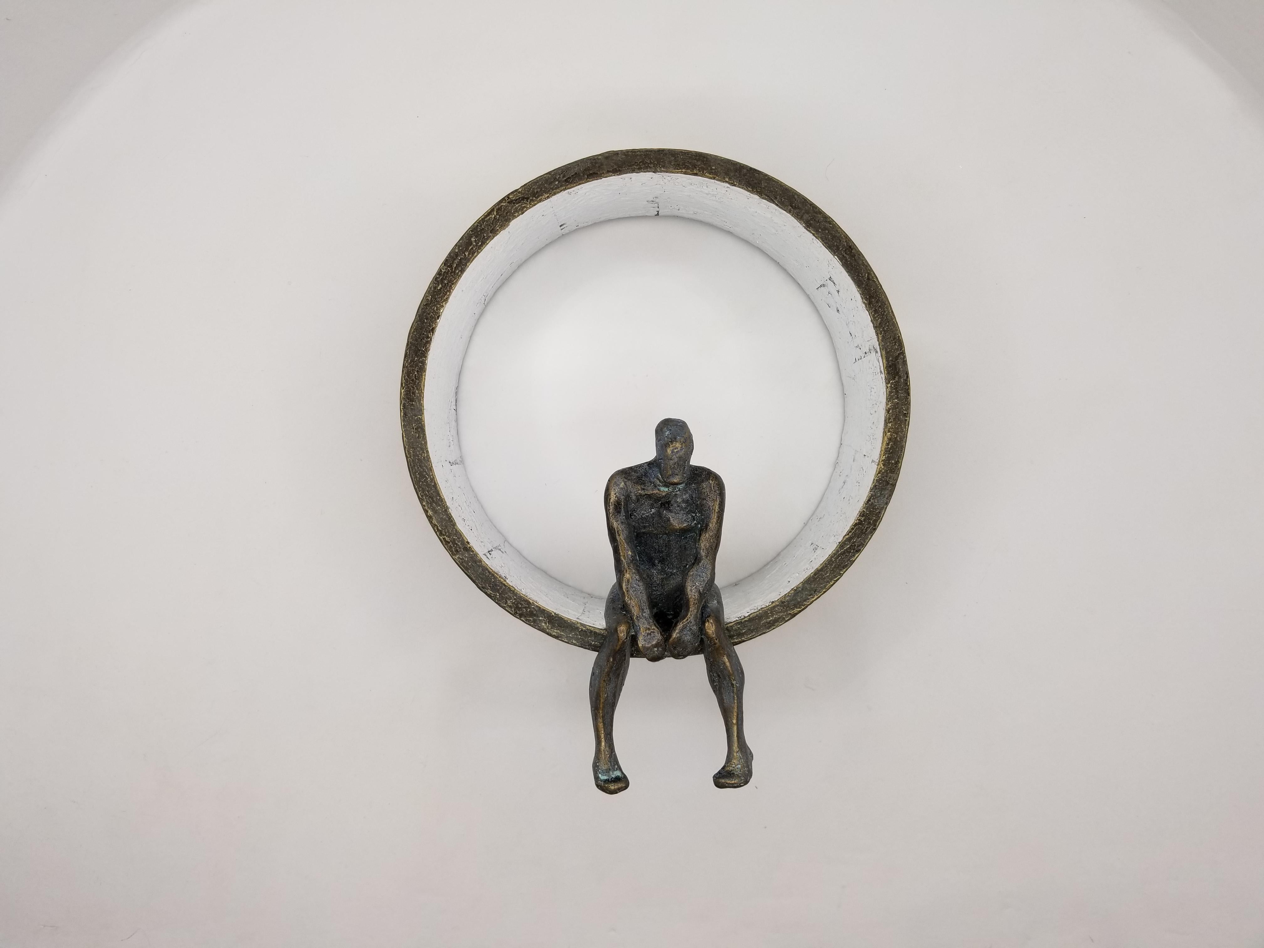 <p>Artistics Comments<br />Fait partie de la série Man on the Moon de l'artiste Yelitza Diaz. Un homme est assis, les épaules voûtées vers l'avant, appuyé sur un anneau. Le personnage est tranquillement assis, les jambes pendantes sur le bord,