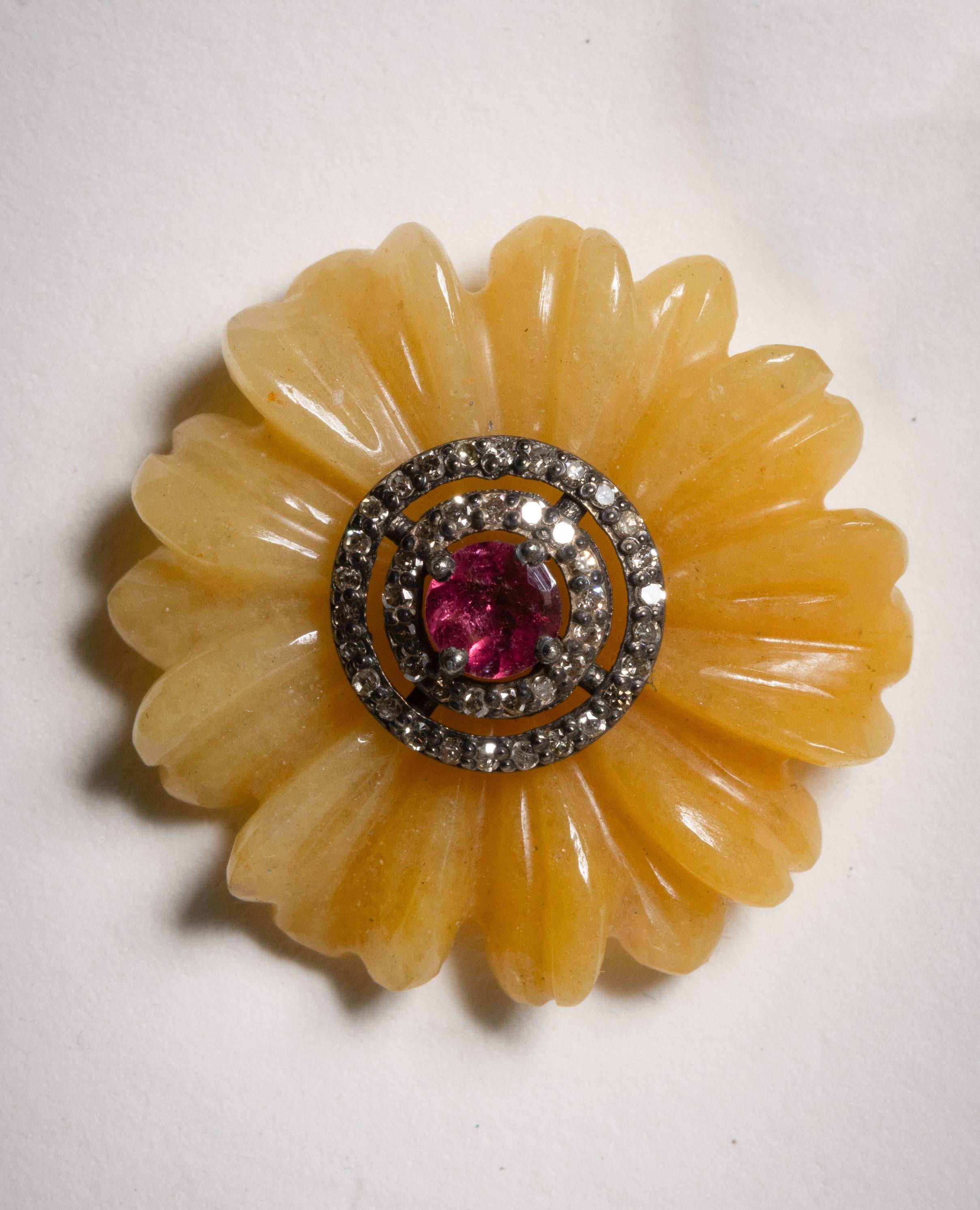 Stud earrings with a flower motif.  Carved yellow agate form the flower petals and the center is a round, faceted pink tourmaline bordered with two rows of pave`-set diamonds.  18K gold post for pierced ears.  The agate totals 2.23 carats, the pink