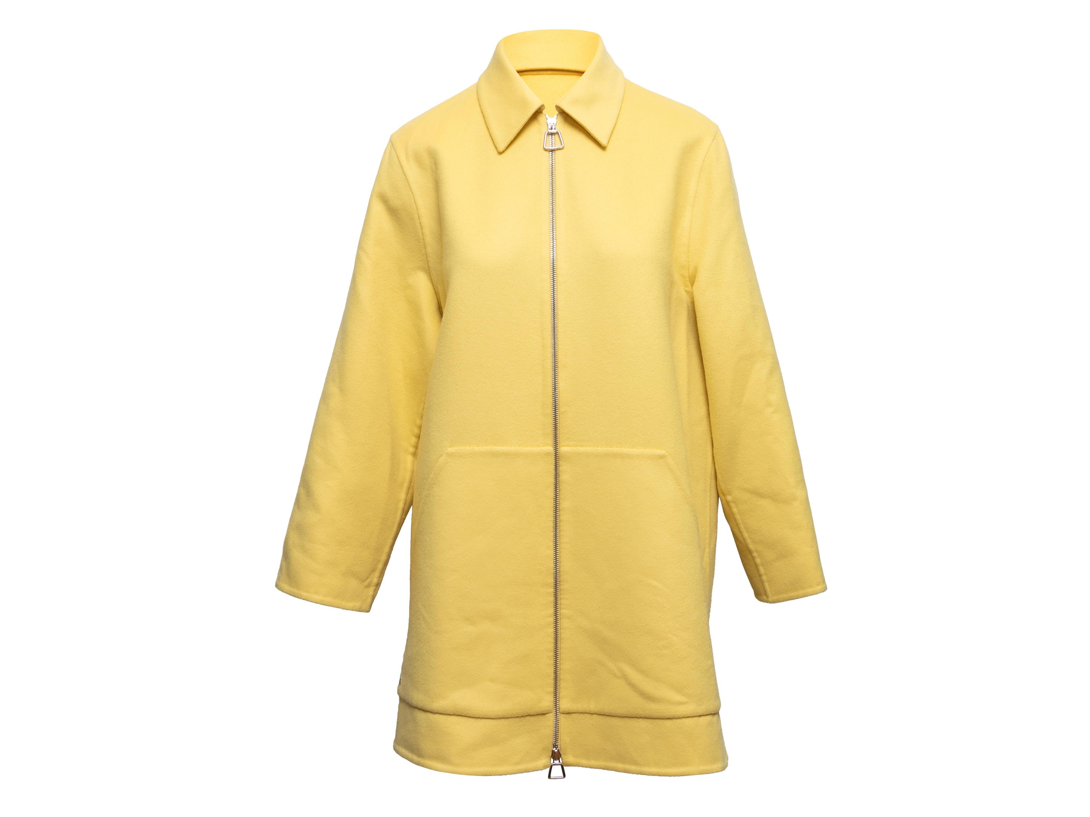  Yellow virgin wool Mimoa coat by Akris. Pointed collar. Dual hip pockets. Zip closure at center front. 41