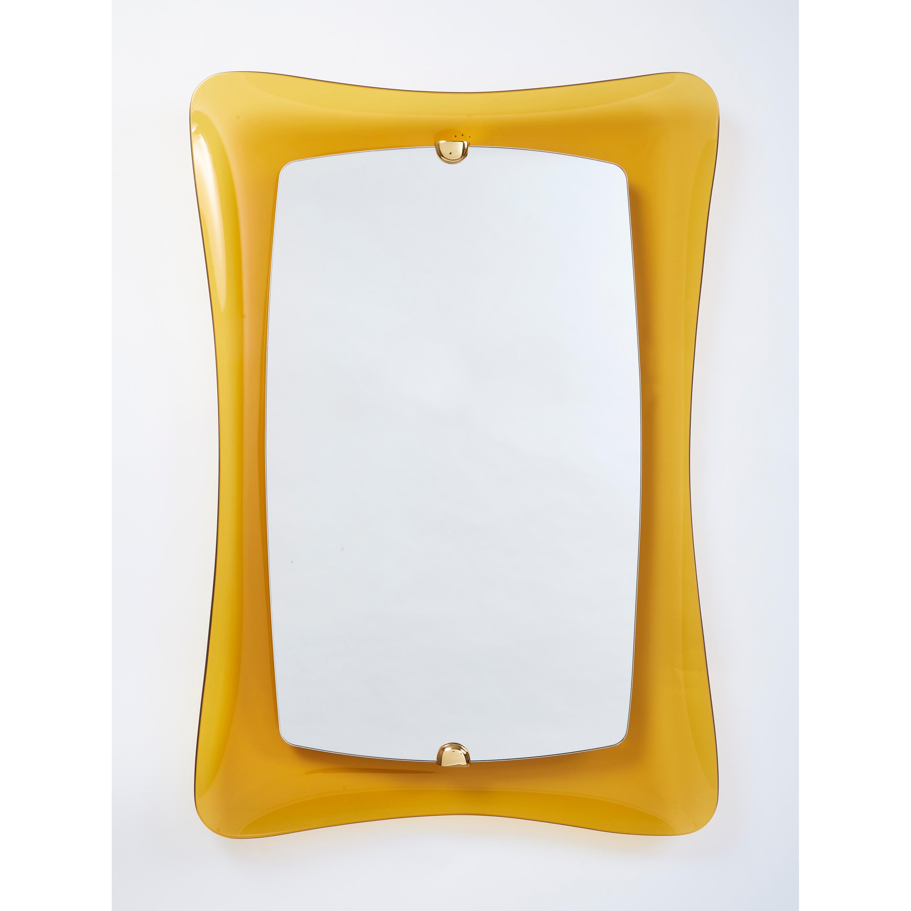 Italy, 1960s
A stunning glass mirror in sensuously rounded forms of yellow amber glass,
with rich bronze mounts.
39.5 H X 27 W X 3 D.