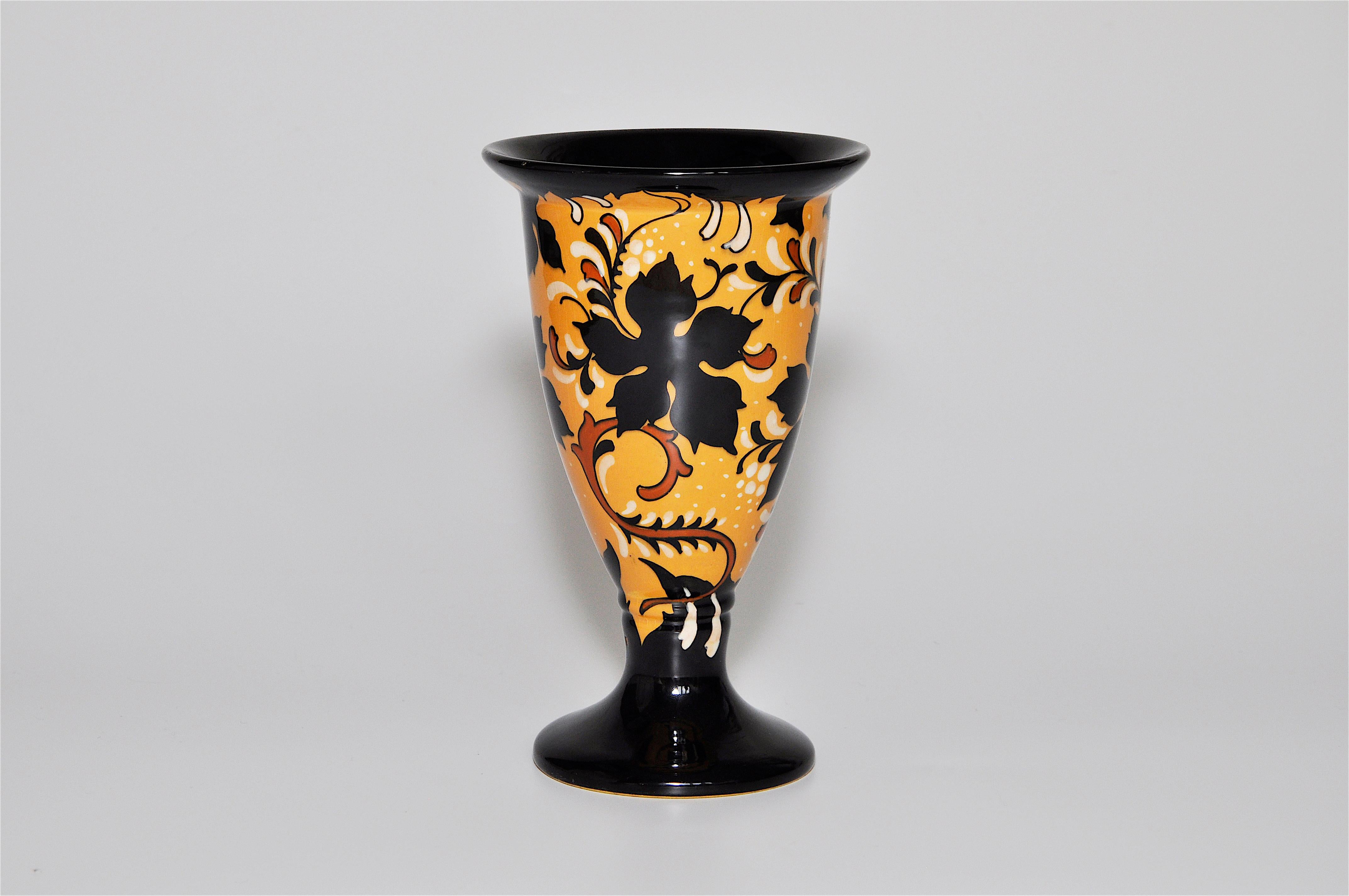 Yellow and black floral Dutch Gouda Art Nouveau Regina pottery ceramic pot vase 

It has an elegant classical poise that is very unique. A sophisticated stylized Art Nouveau floral and leaf organic design with a high gloss finish. The body has a