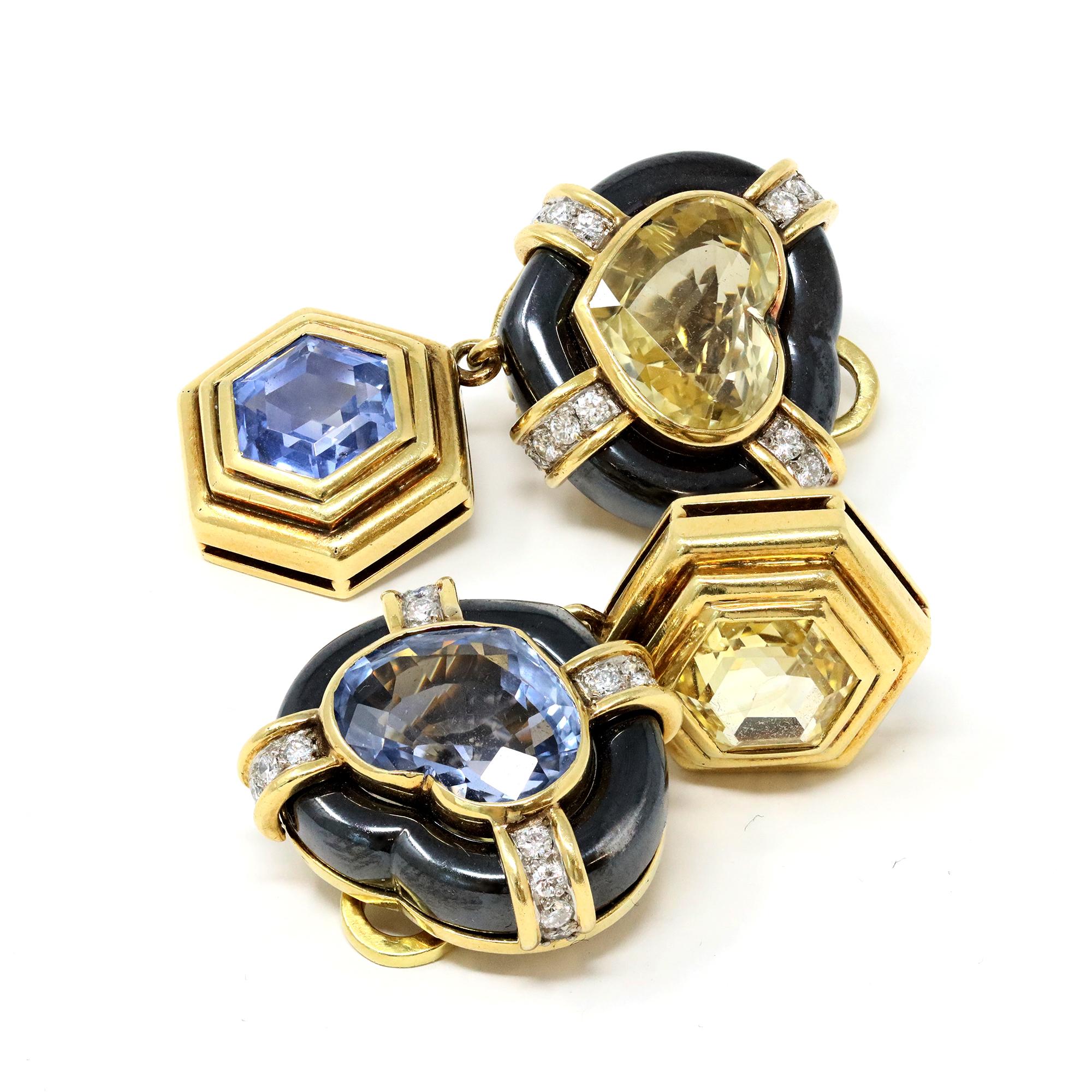 Pair of 18 karat yellow gold, yellow and blue sapphire, hematite and diamond ear-clips, the tops designed as hearts set with heart-shaped yellow and blue sapphires, within hematite frames accented by round diamonds weighing approximately 0.60 carat,