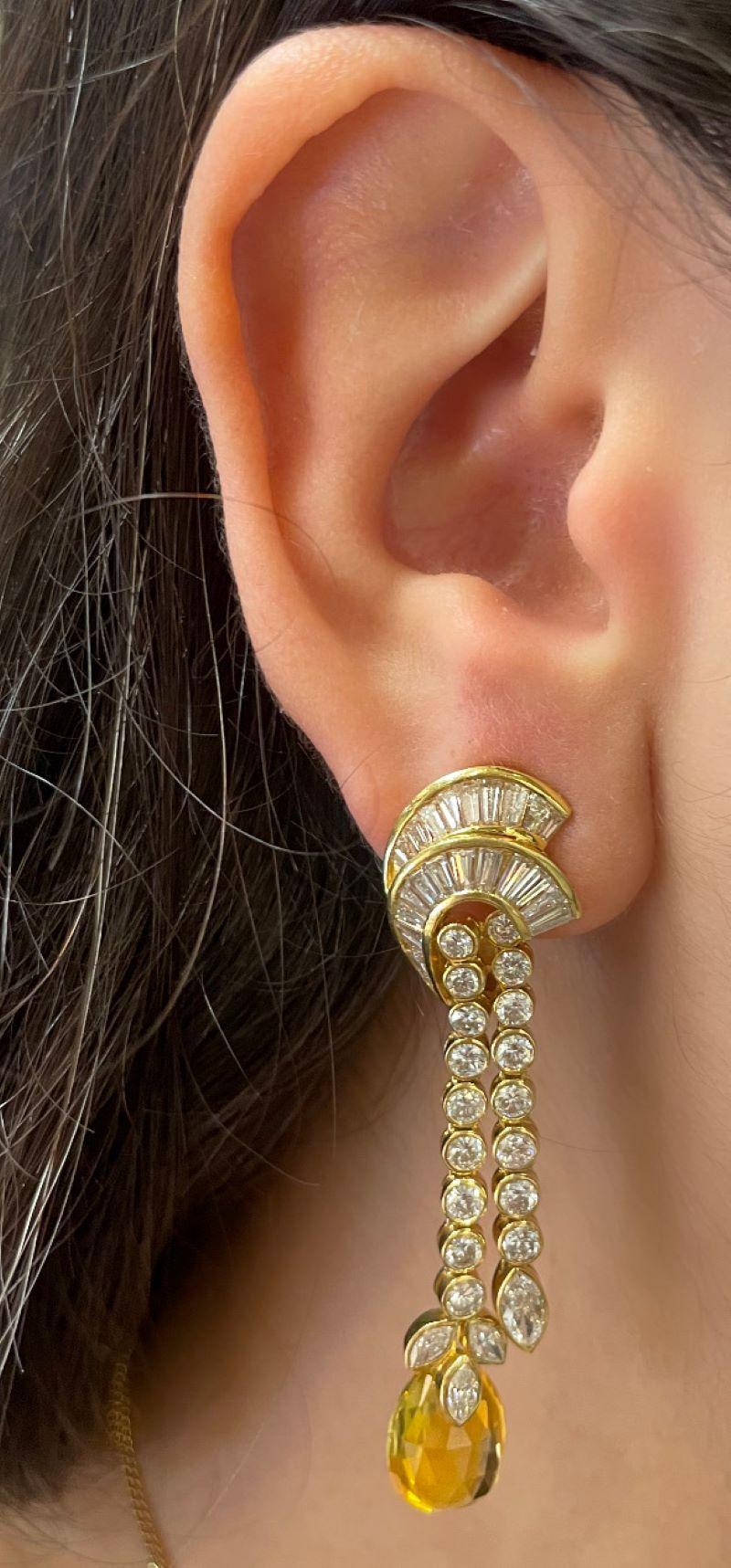 Yellow and Blue Sapphire Earrings 

A pair of yellow and blue oval sapphire drop earrings adorned with marquise, oval, and baguette-cut diamonds. 

Total Approximate Briolette Sapphire Weight: 15.37 carats
Total Approximate Diamond Weight: