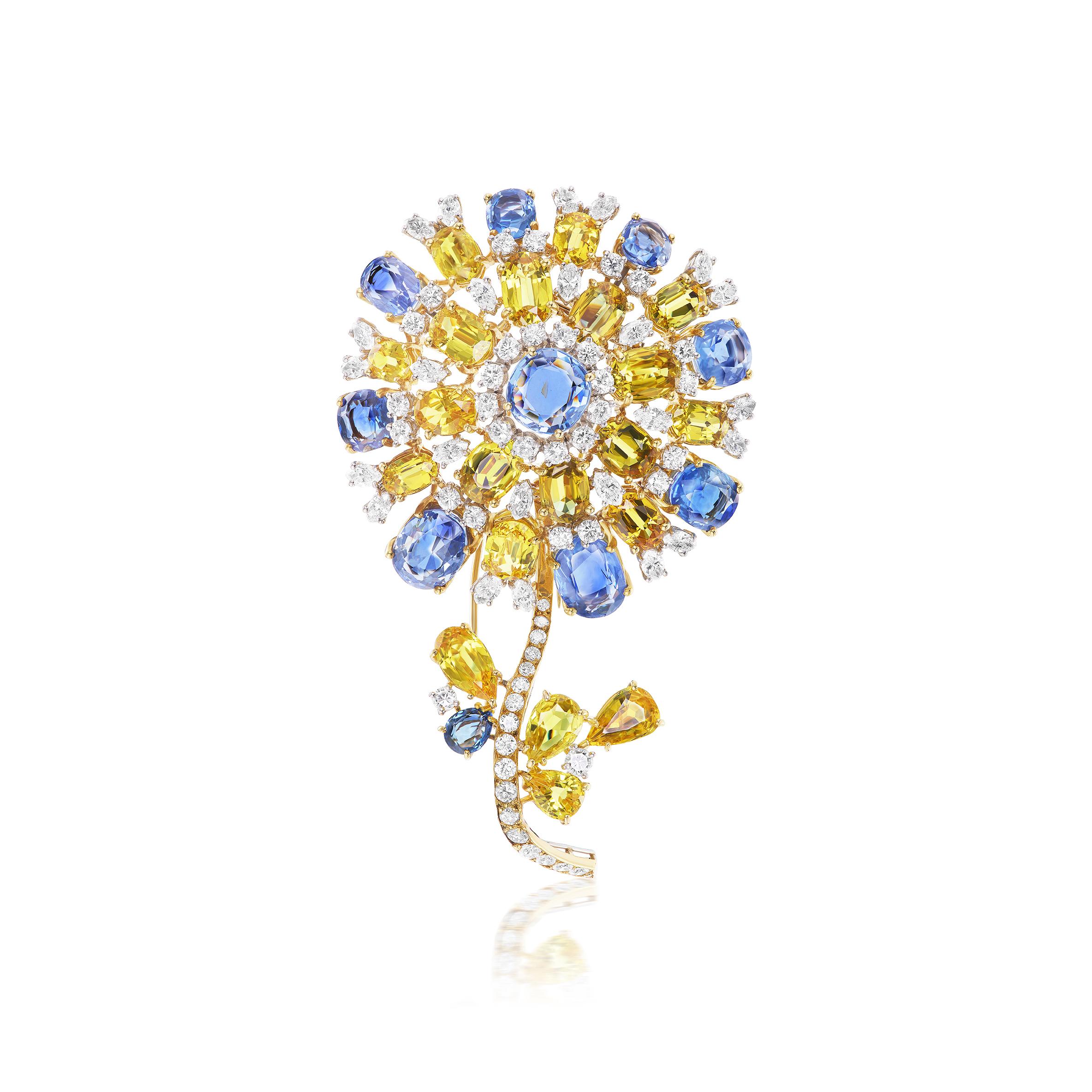 This magnificent and impressive brooch features 10 oval blue sapphires weighing approximately 24 carats, 20 mixed shape yellow sapphires weighing approximately 45 carats, and 24 marquise and 49 round brilliant diamonds weighing approximately 8